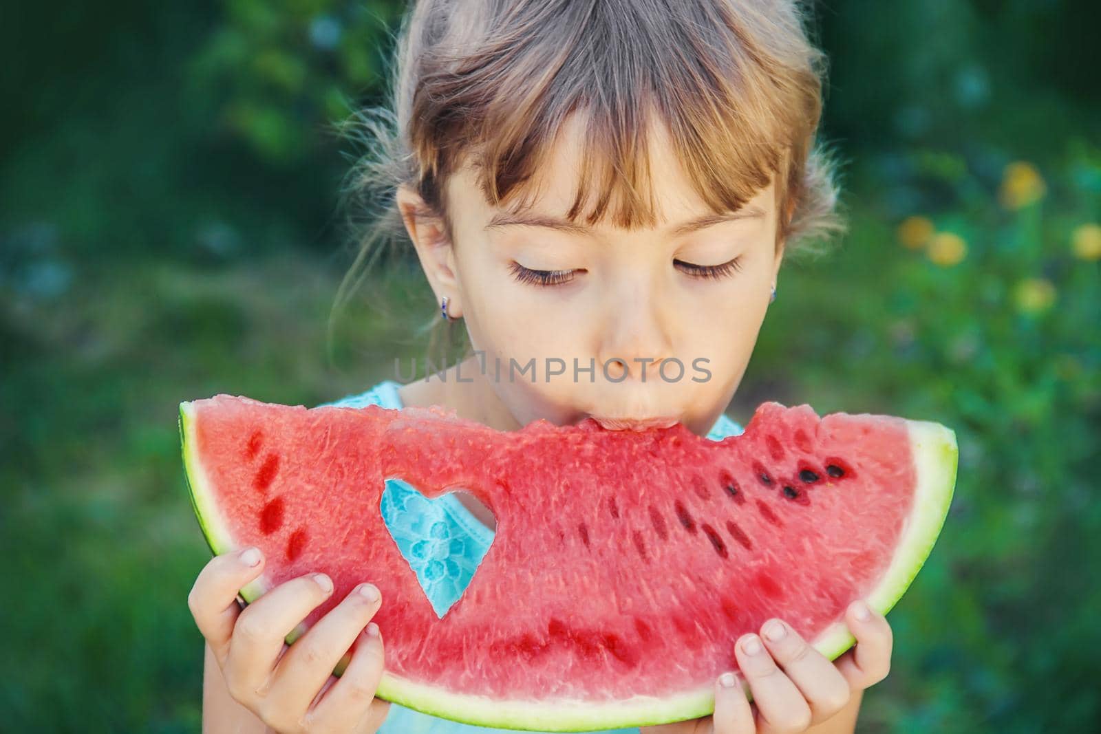 A child eats watermelon. Selective focus. food. by yanadjana