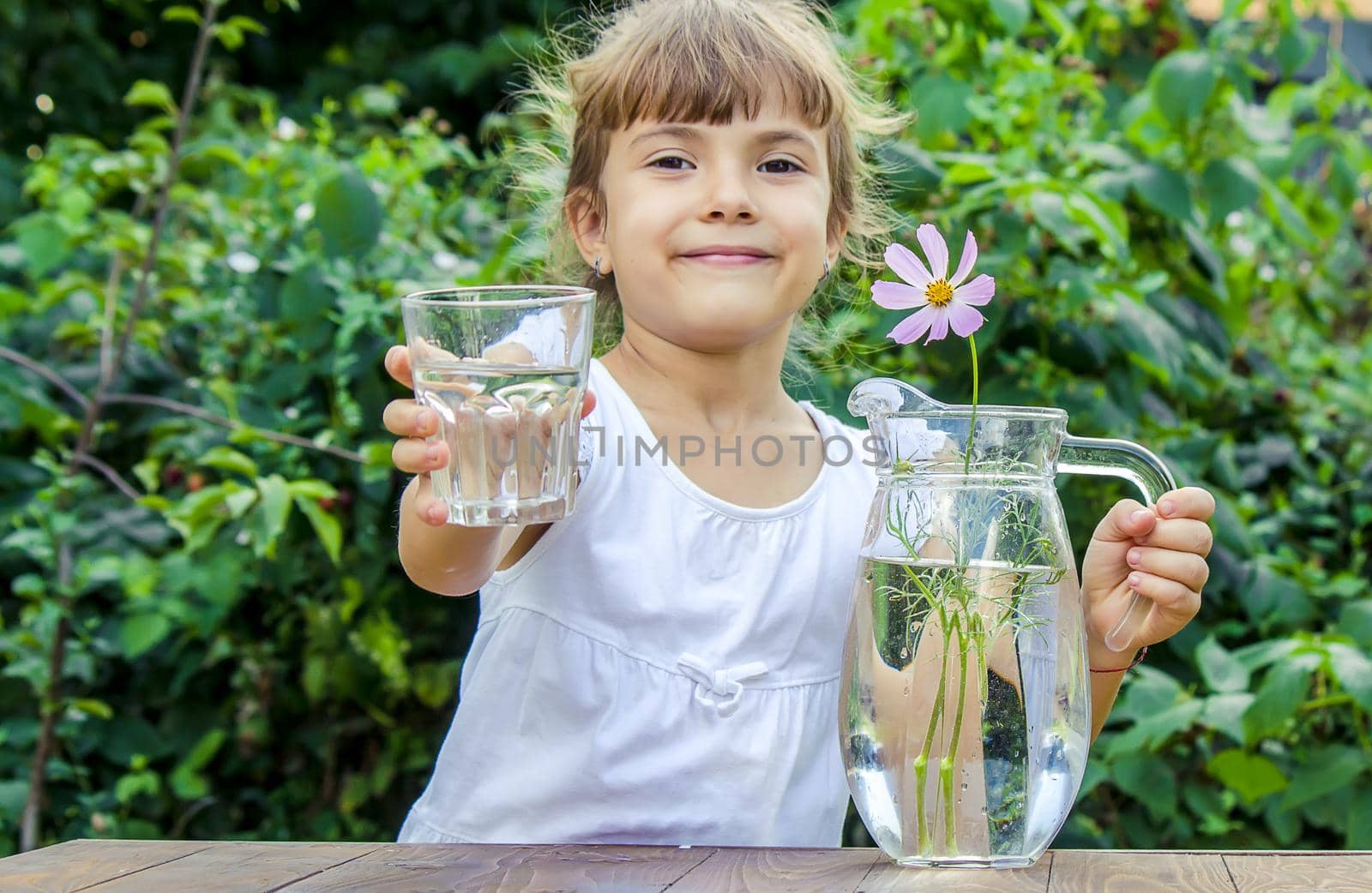 The child drinks clean water in summer. Selective focus. by yanadjana