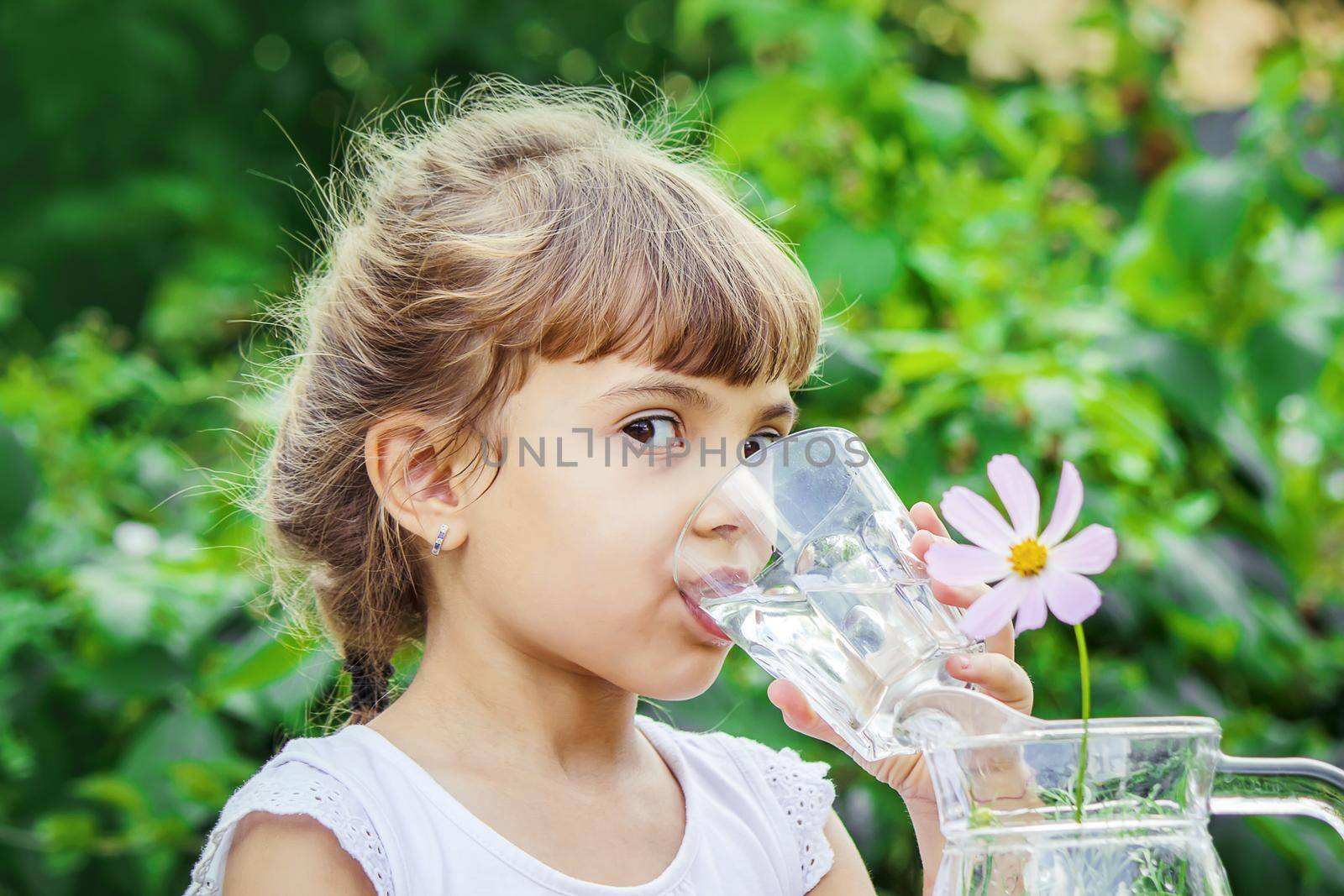 child glass of water. selective focus. nature. by yanadjana