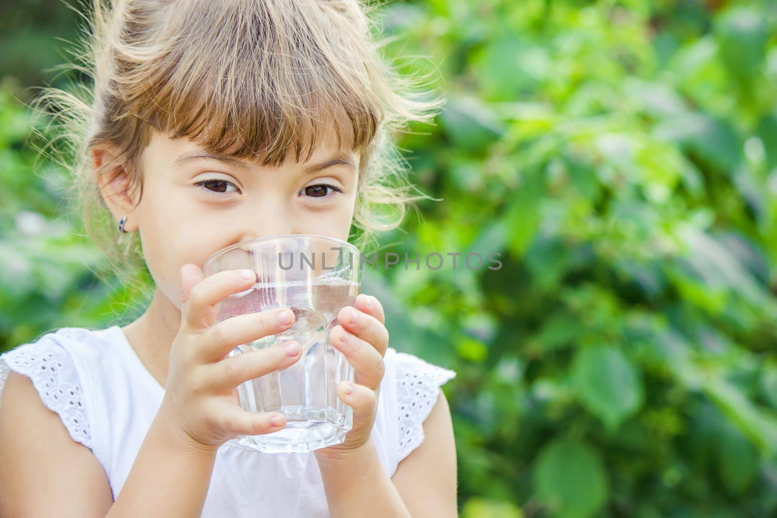 child glass of water. selective focus. food and drink. by yanadjana