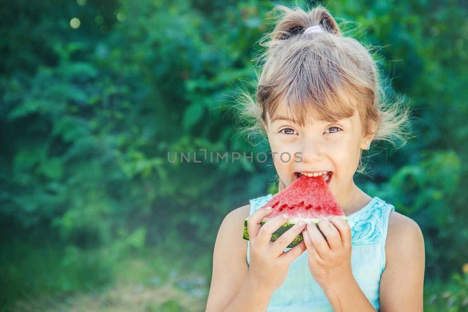 A child eats watermelon. Selective focus. nature.