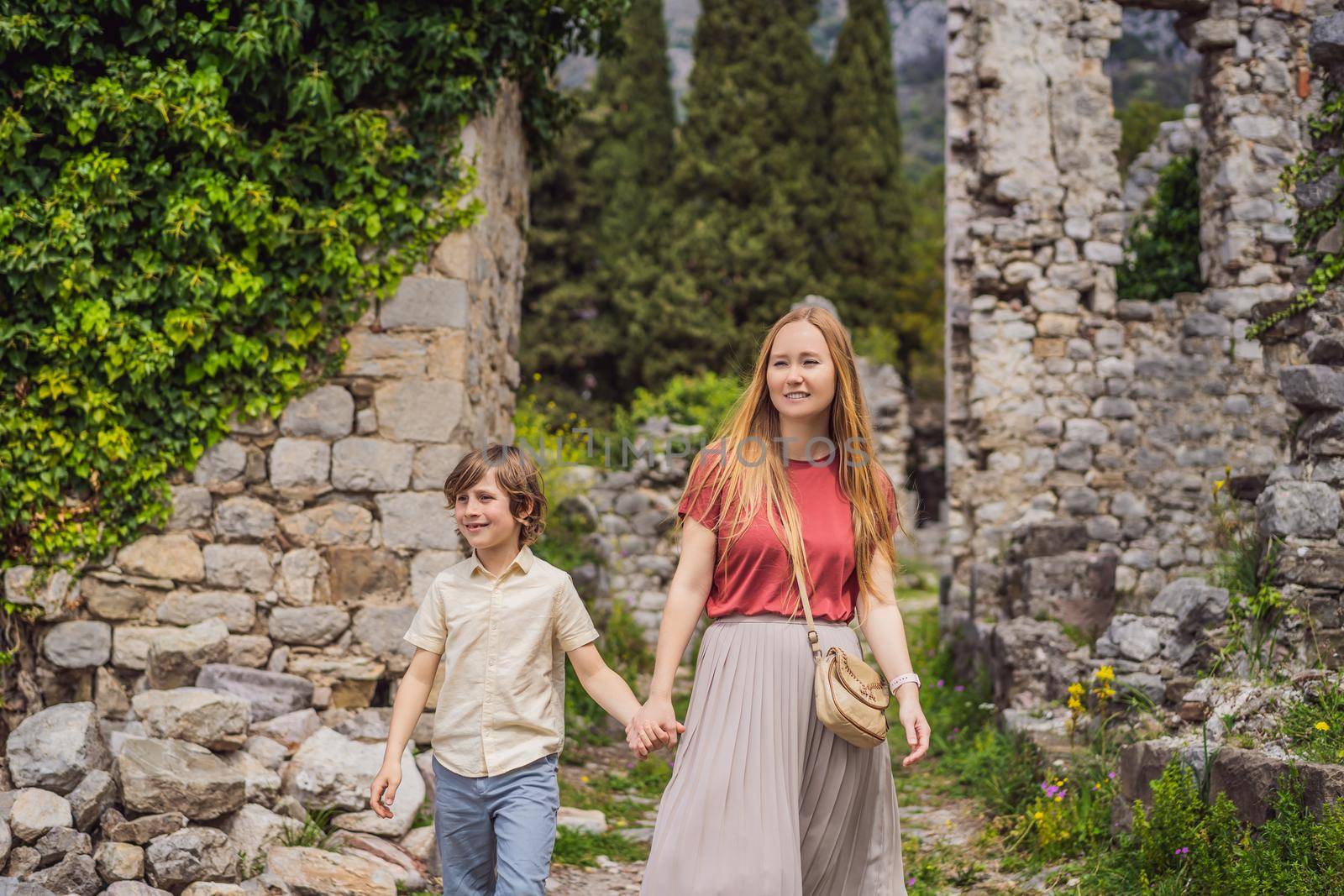 Mom and son tourists walks through the old town of Bar in Montenegro. Happy tourist walks in the mountains. Suburbs of the city of Bar, Montenegro, Balkans. Beautiful nature and landscape.