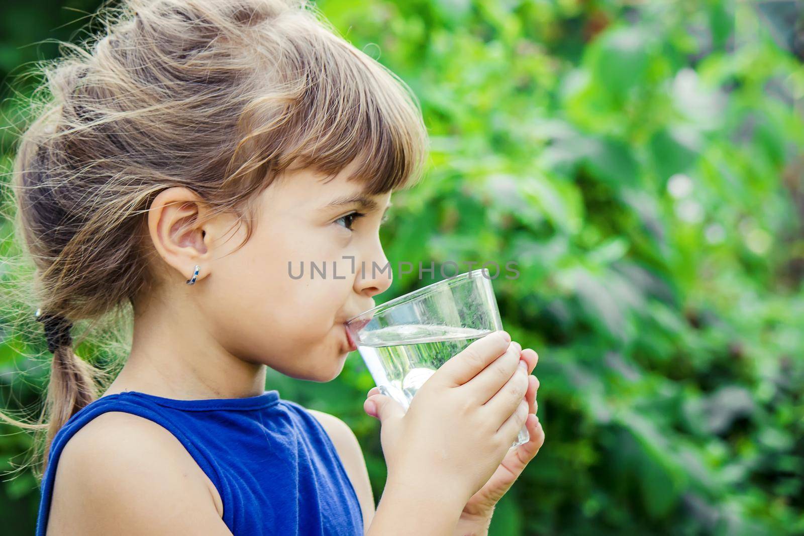 child glass of water. selective focus. nature. by yanadjana