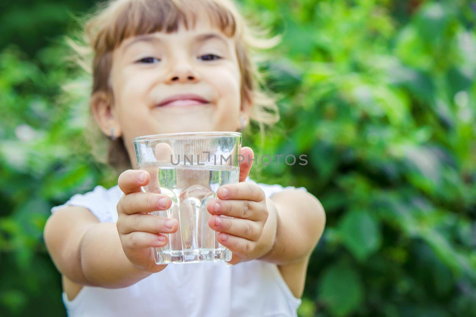 child glass of water. selective focus. nature. by yanadjana