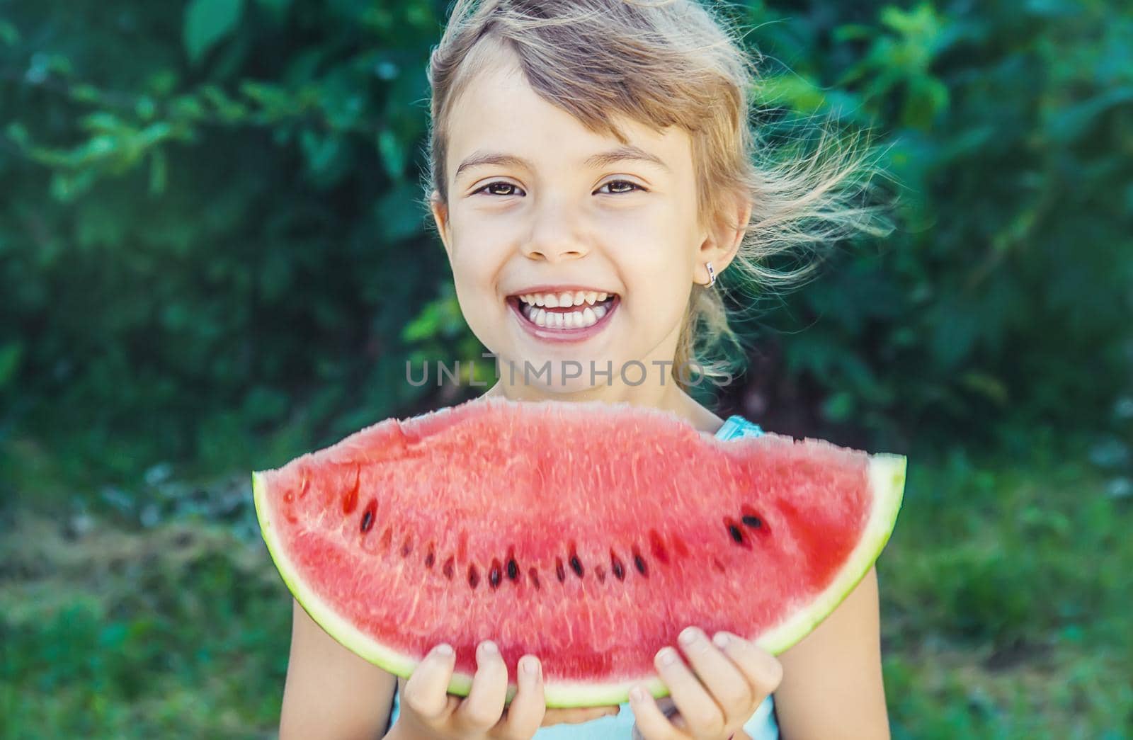 A child eats watermelon. Selective focus. nature.