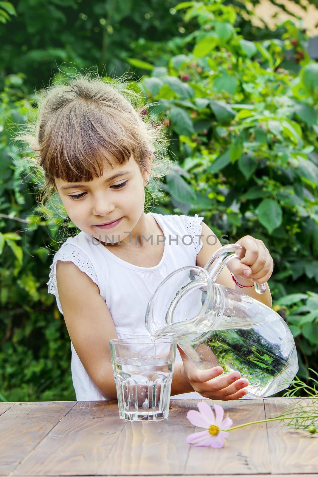 child glass of water. selective focus. nature. by yanadjana