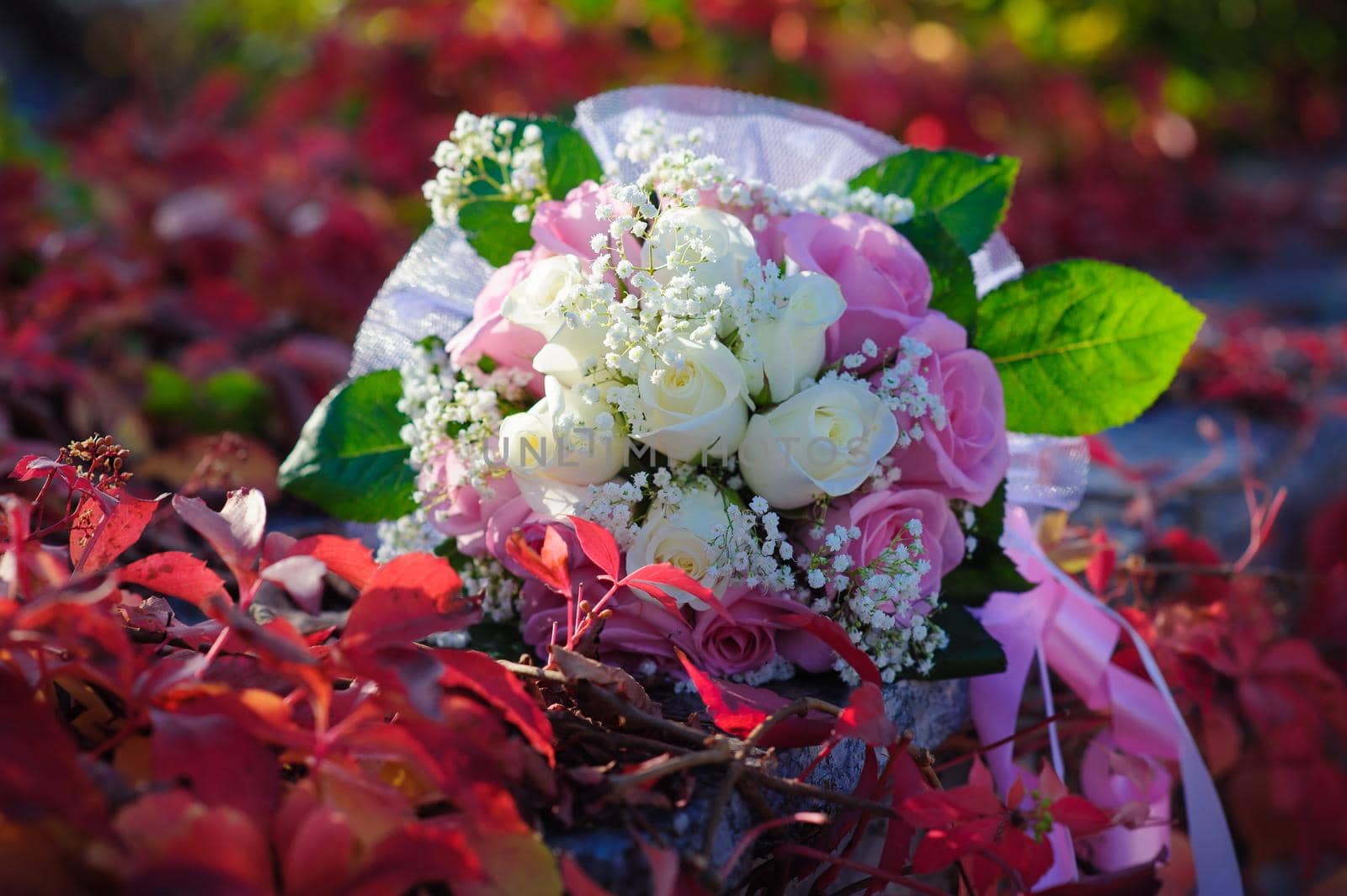 Bridal wedding bouquet of flowers. Wedding bouquet of pink and white roses lying on a grass.