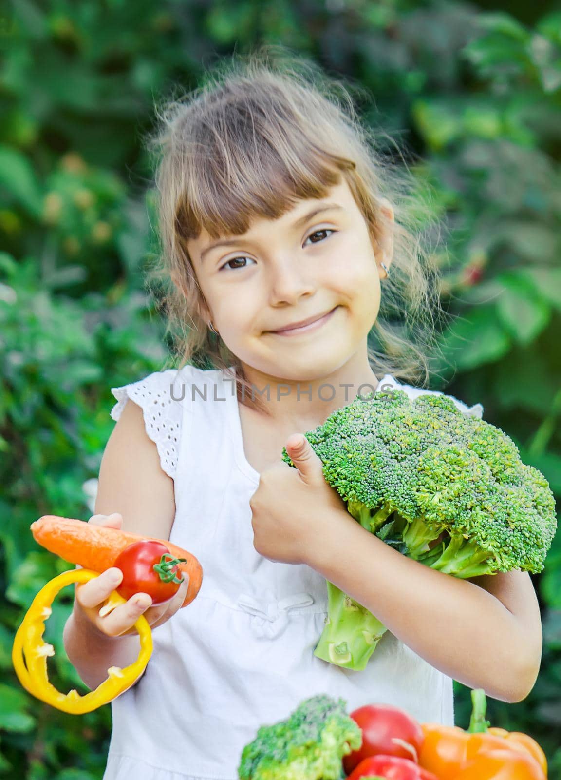 child eats vegetables. Summer photo. Selective focus nature