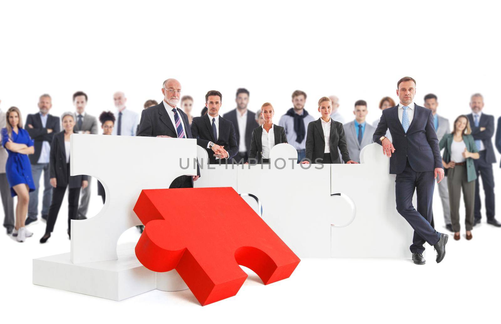 Business team and big puzzle by ALotOfPeople