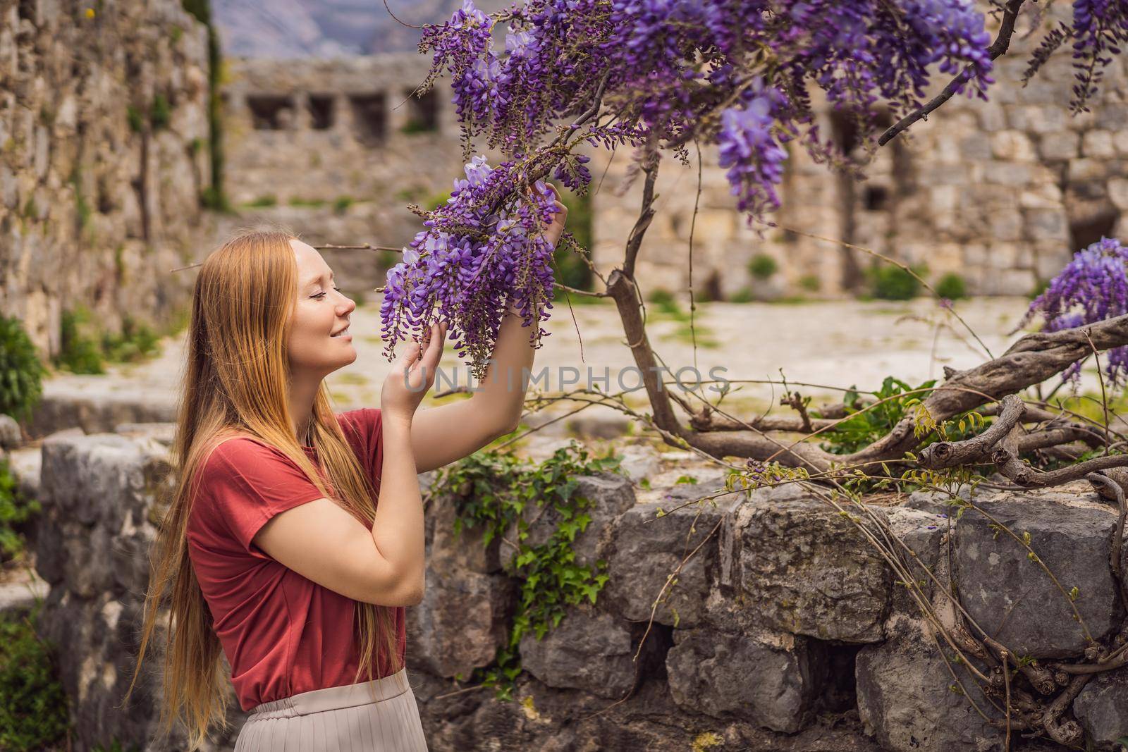 Woman tourist walks through the old town of Bar in Montenegro. Happy tourist walks in the mountains. Suburbs of the city of Bar, Montenegro, Balkans. Beautiful nature and landscape.