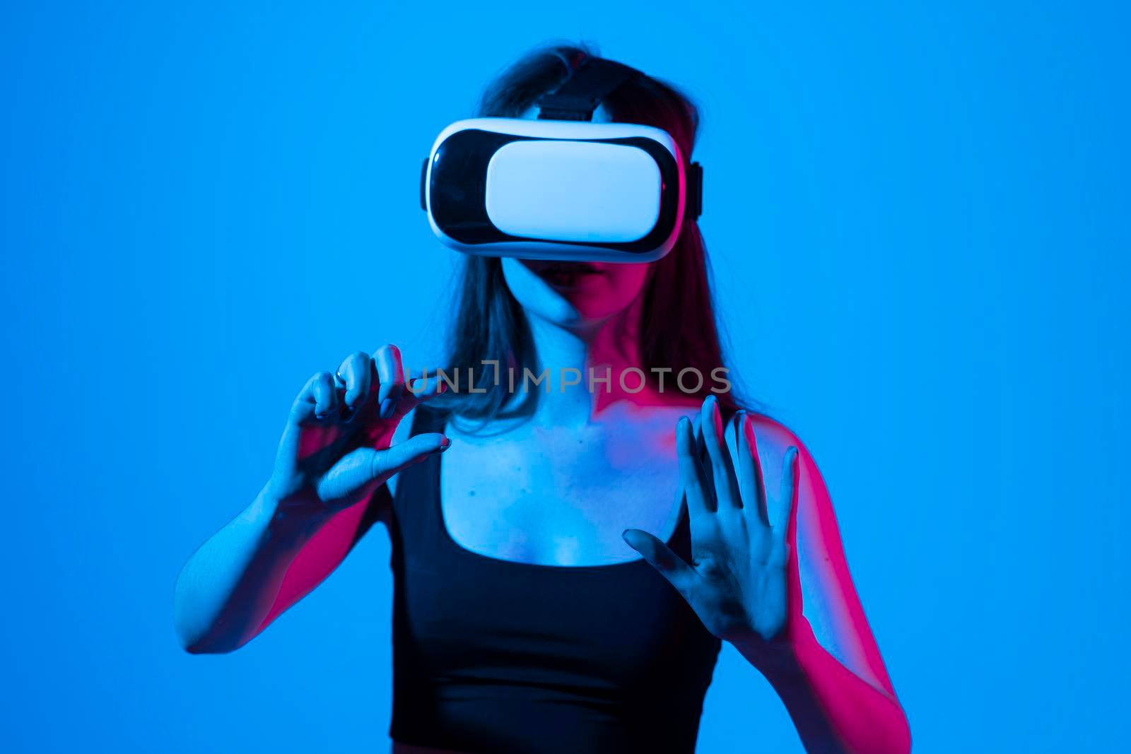 Young handsome brunette woman wearing virtual headset. Excited hipster girl using VR glasses. Virtual gadgets for entertainment, work, free time and study
