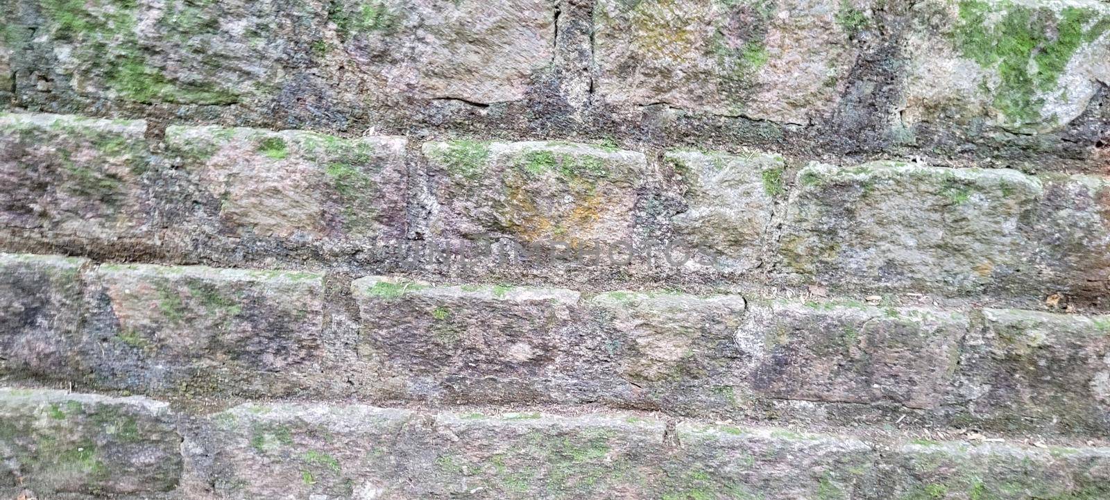 old brick wall of dark stones by sarsa