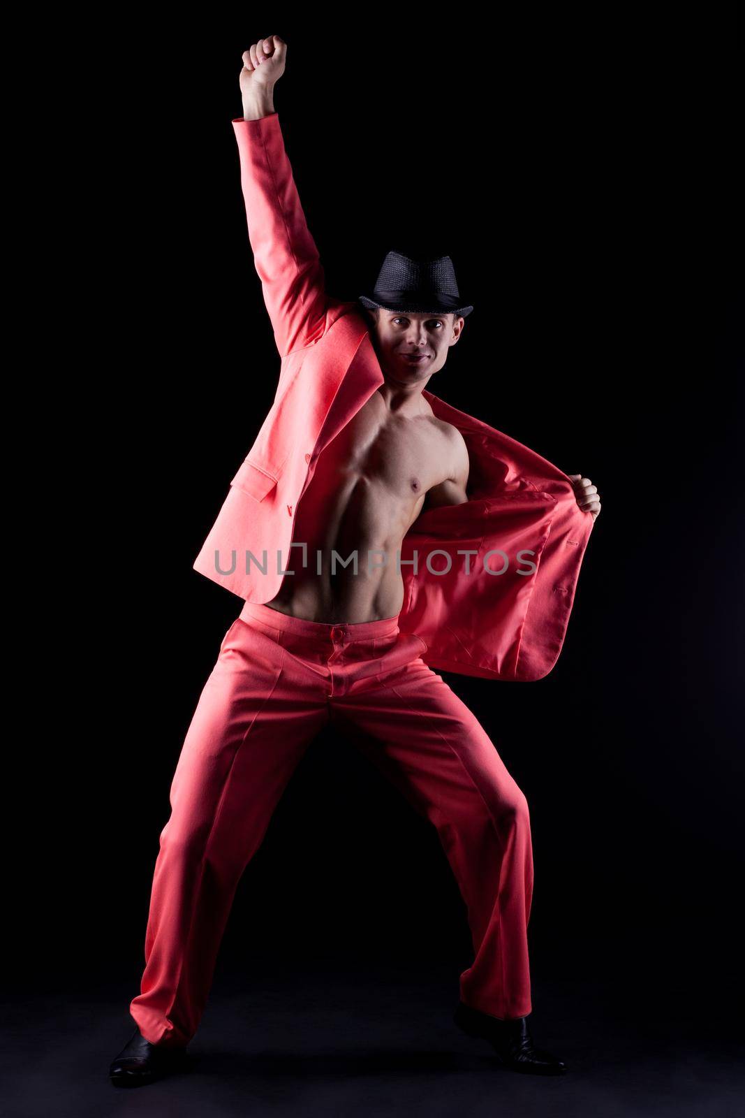 Sexy man in red suit Stripper on black background
