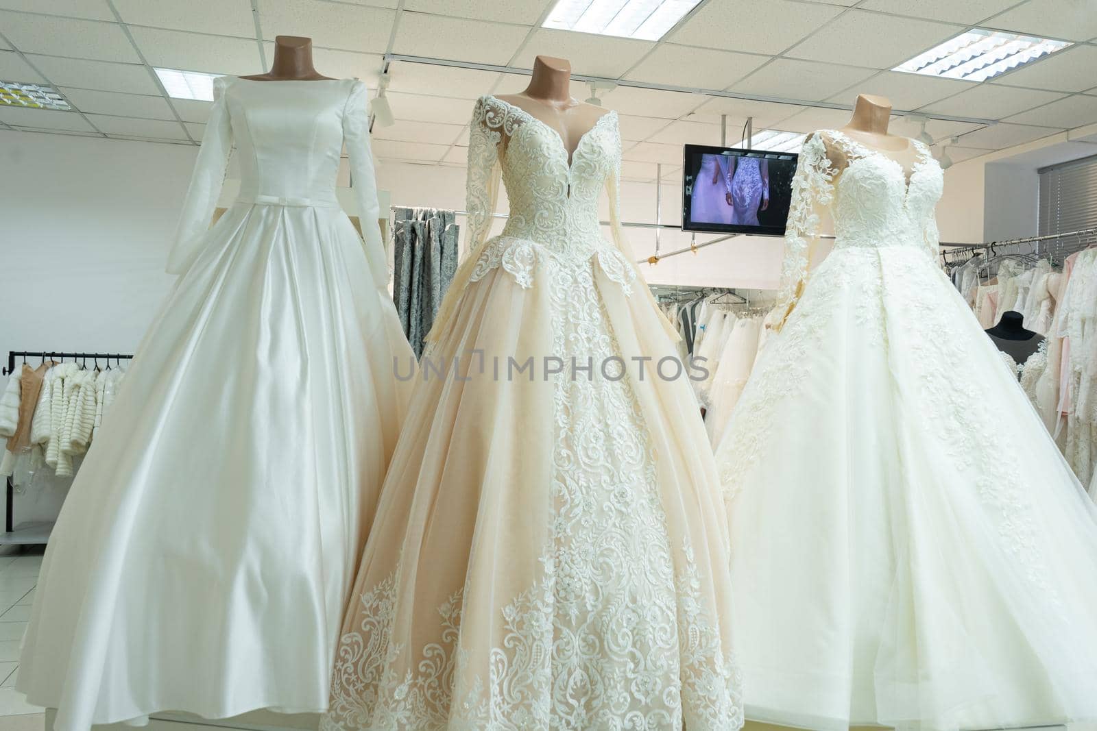 Three chic wedding dresses on mannequins. Three different models of beautiful wedding dresses by Serhii_Voroshchuk