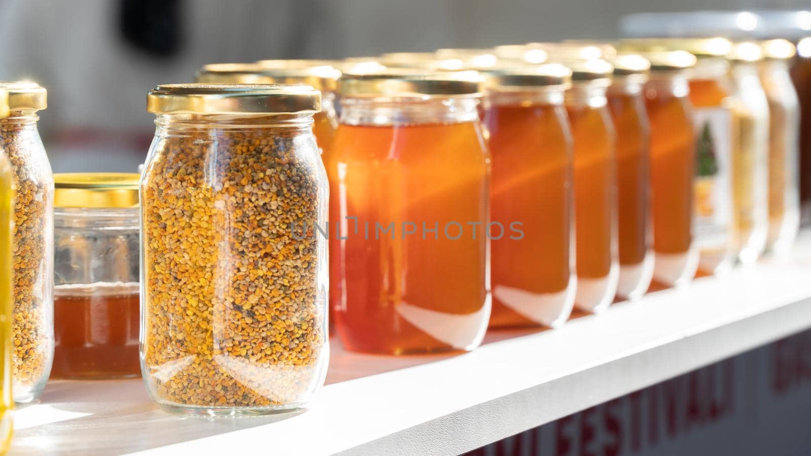 Glass jars with beekeeping products, honey and propolis by voktybre