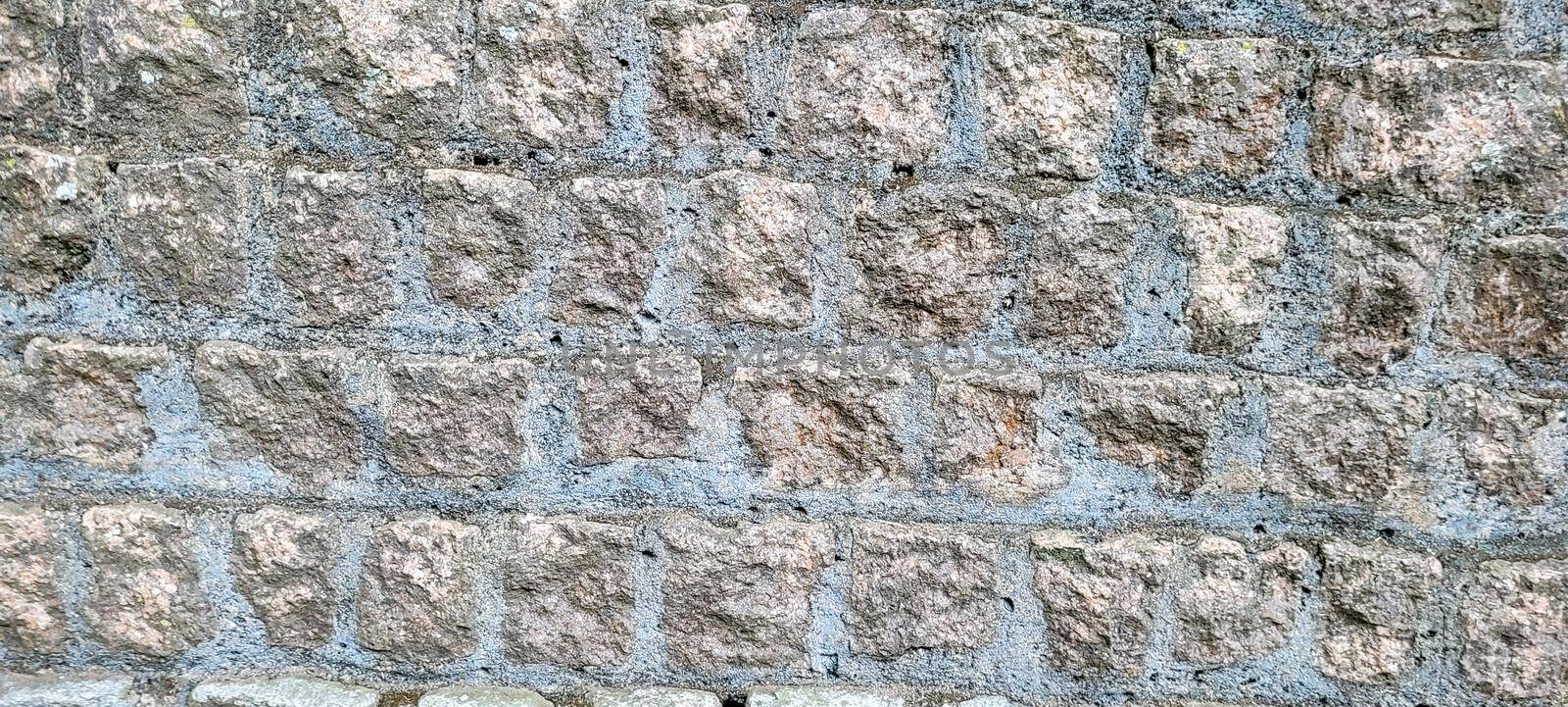 old brick wall of dark stones, which can be used as a background