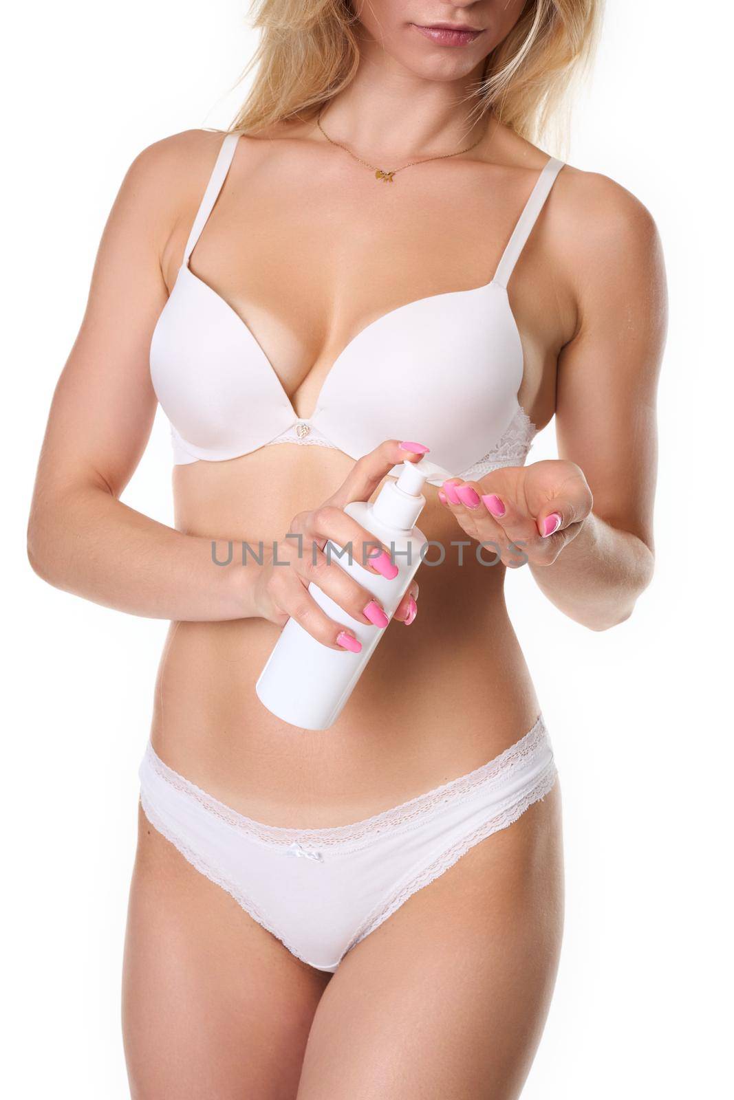 blonde haired woman uses body lotion. studio photography on a white background by Jarosz