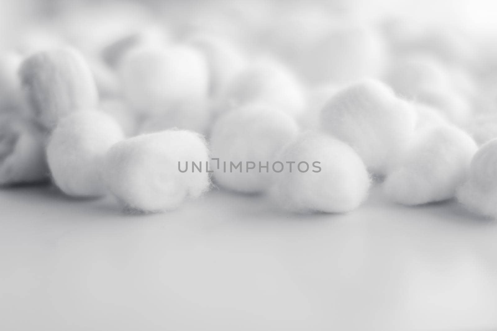 Cosmetology, branding and cleanliness concept - Organic cotton balls background for morning routine, spa cosmetics, hygiene and natural skincare beauty brand product as healthcare and medical design