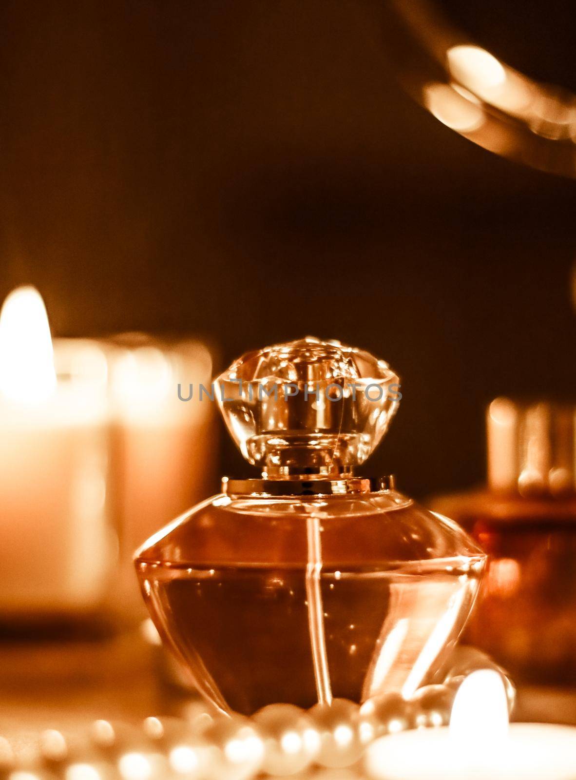 Perfumery, cosmetics branding and luxe concept - Perfume bottle and vintage fragrance on glamour vanity table at night, pearls jewellery and eau de parfum as holiday gift, luxury beauty brand present