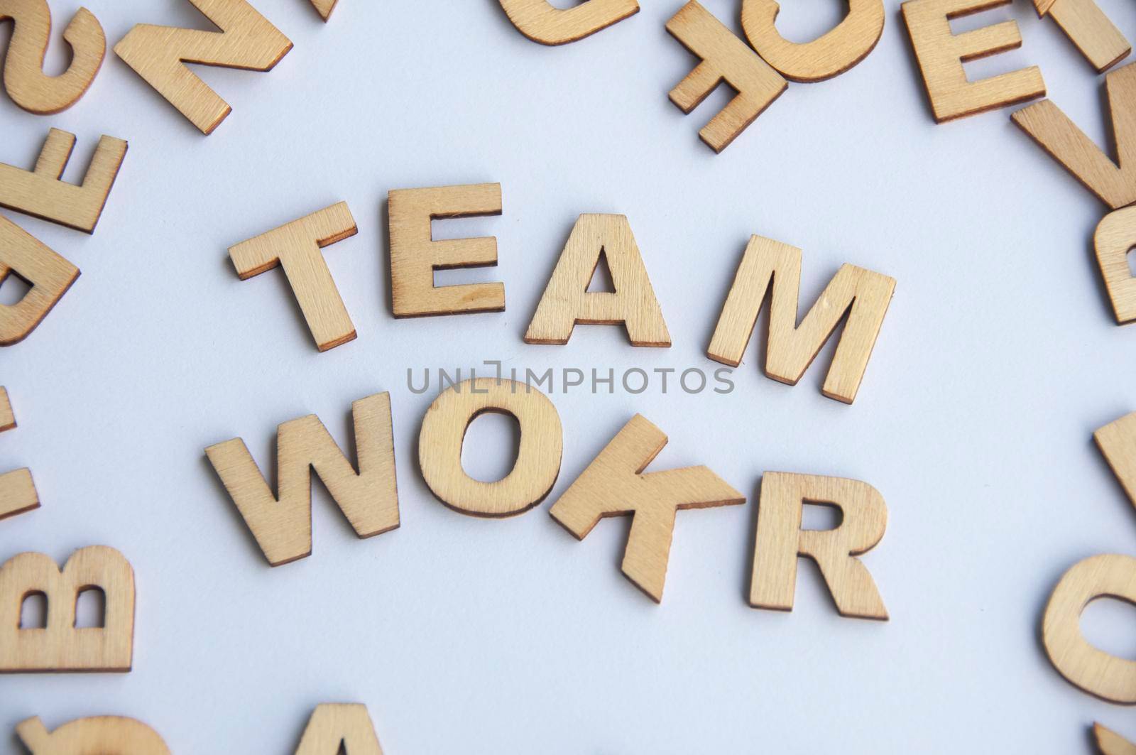 Teamwork wooden text on while cover background. Teamwork concept.