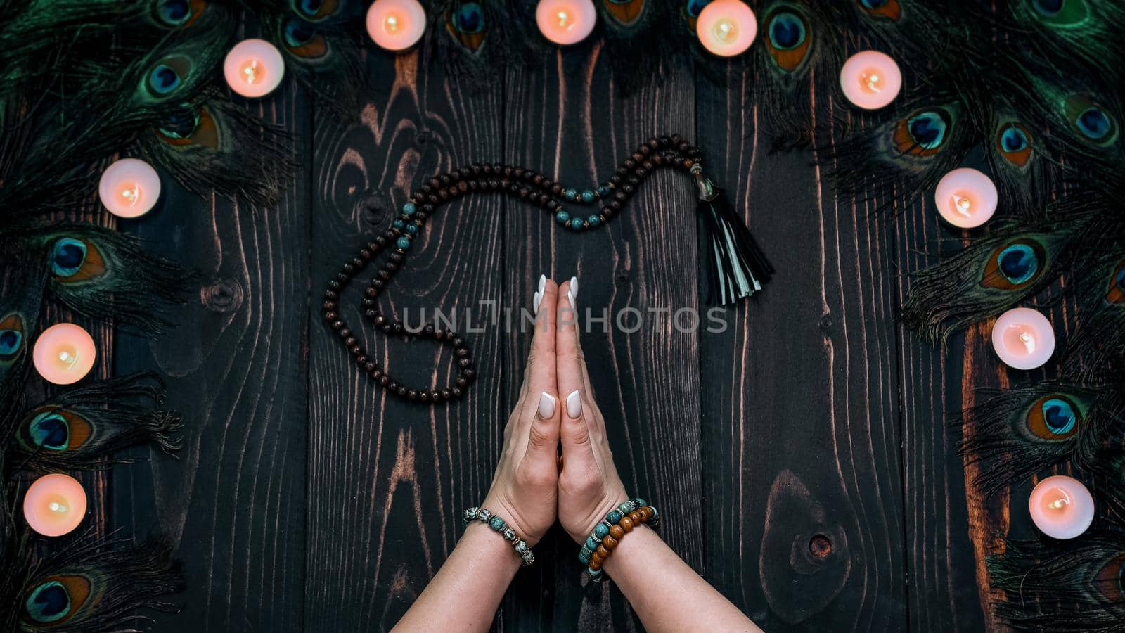 Praying woman meditating, reading mantras, directs thoughts, requests or gratitude to universe. Top view. Spirituality, religion, God concept. High quality photo