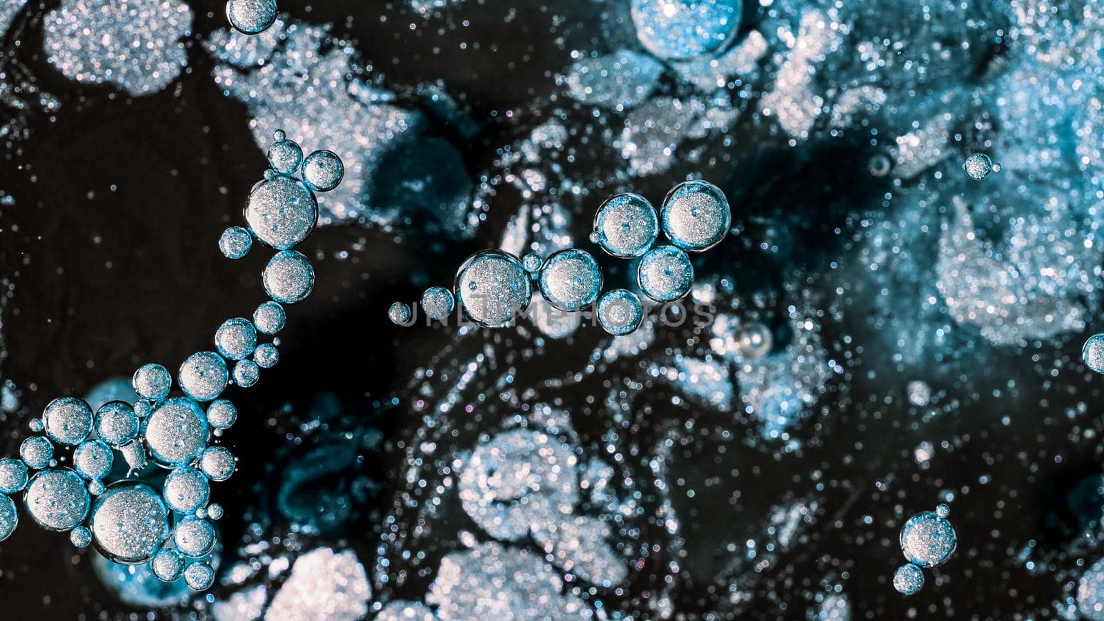 Abstract of frost bubbles bursts and dissolves in black paint. Blue sphere shapes. Detailed background, beautiful design, ice balloons texture. by kristina_kokhanova