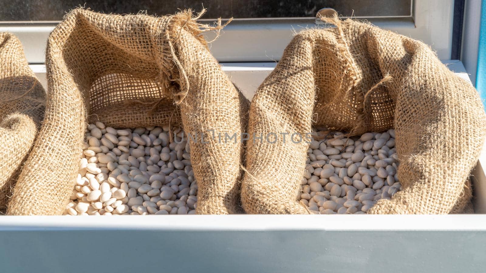 Legume seeds in a bag of burlap woven material. High quality photo