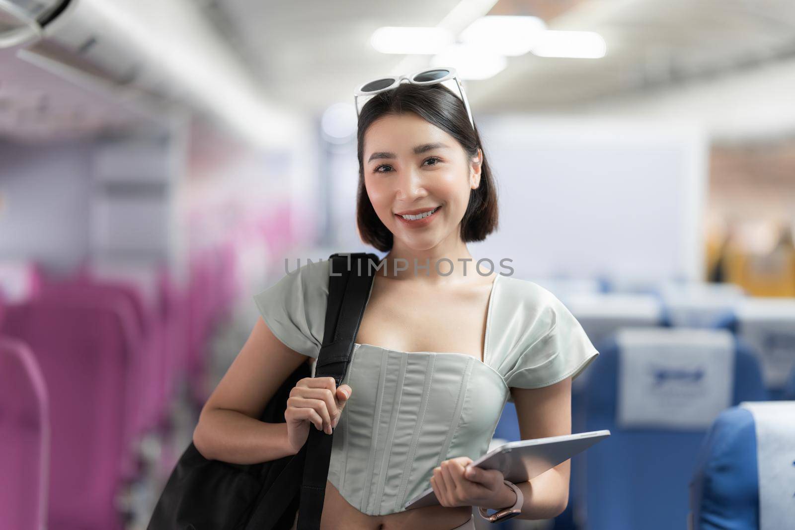 Backpacker asian woman in the airplane while to destination. Travel concept by itchaznong