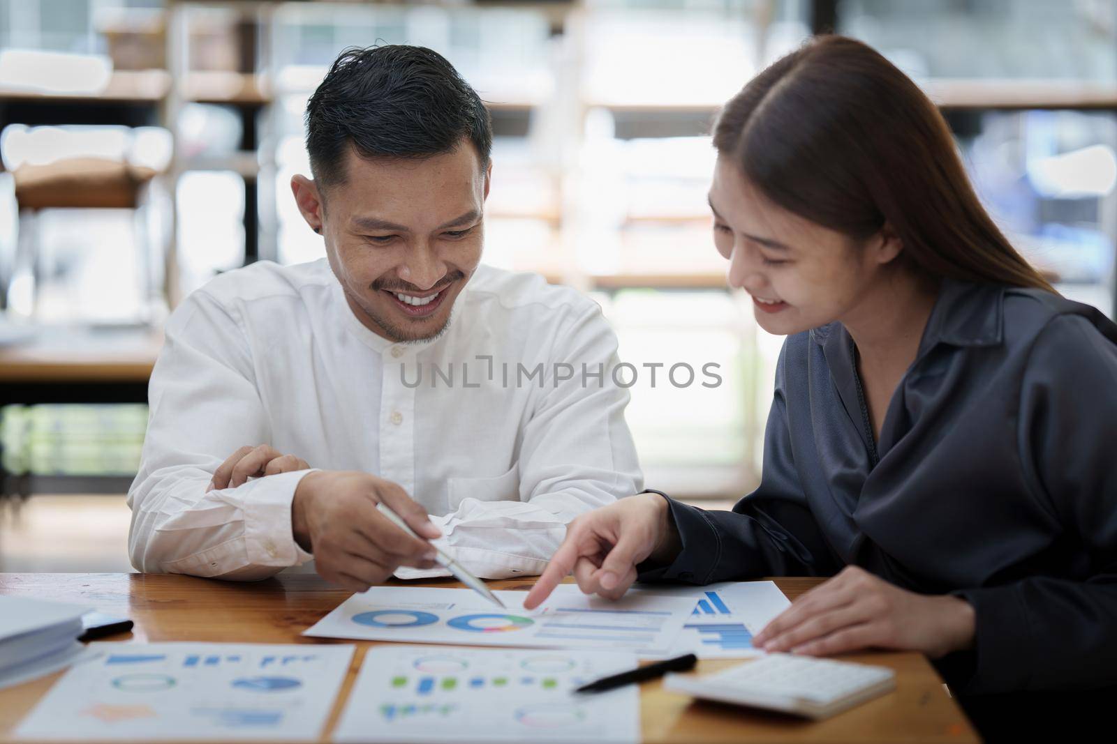 Two asian fund manager brainstorming new business project finance investment concept.