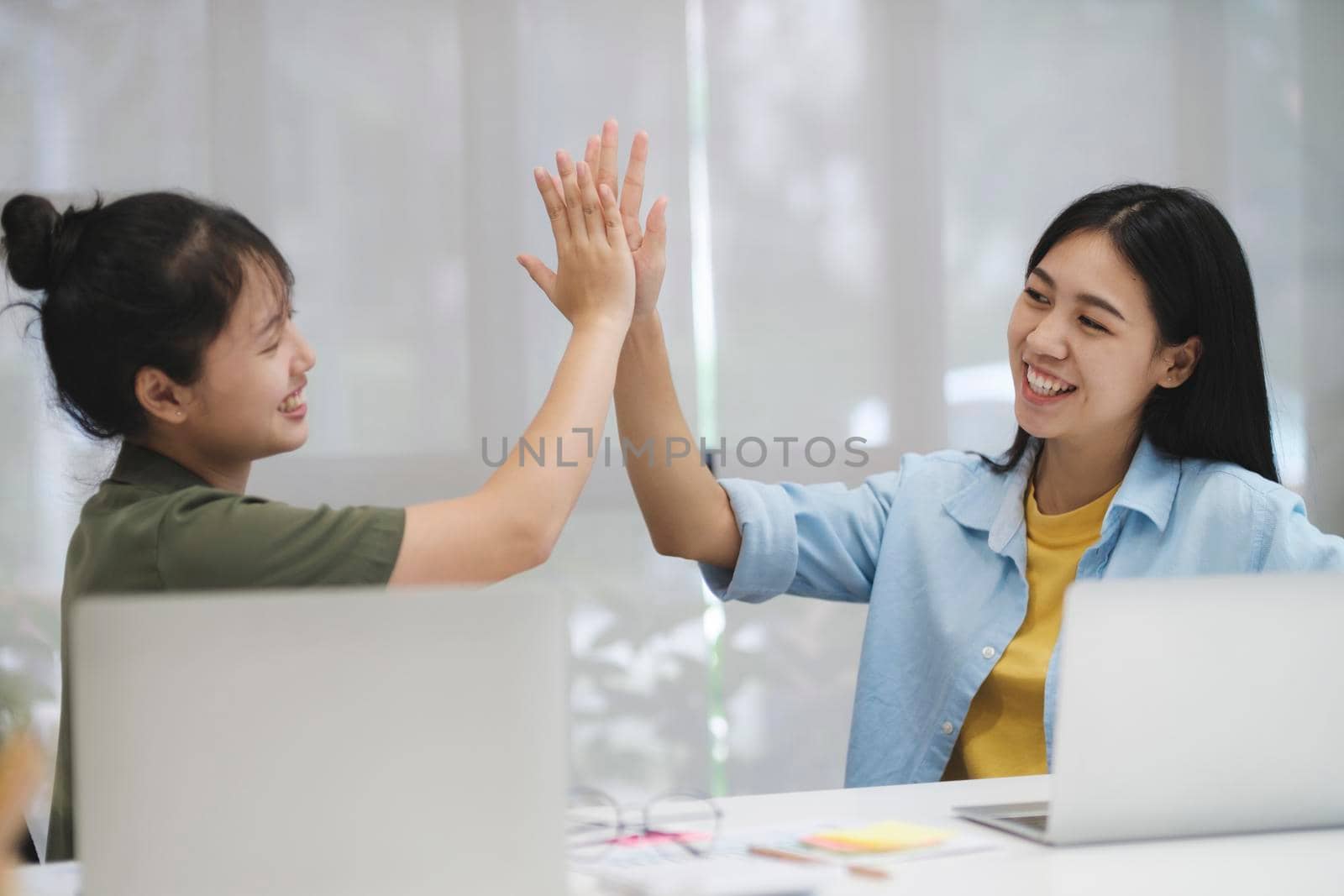 Startup Happy asian business teamwork celebrating business success, giving high five show support share common victory, concept business teamwork.