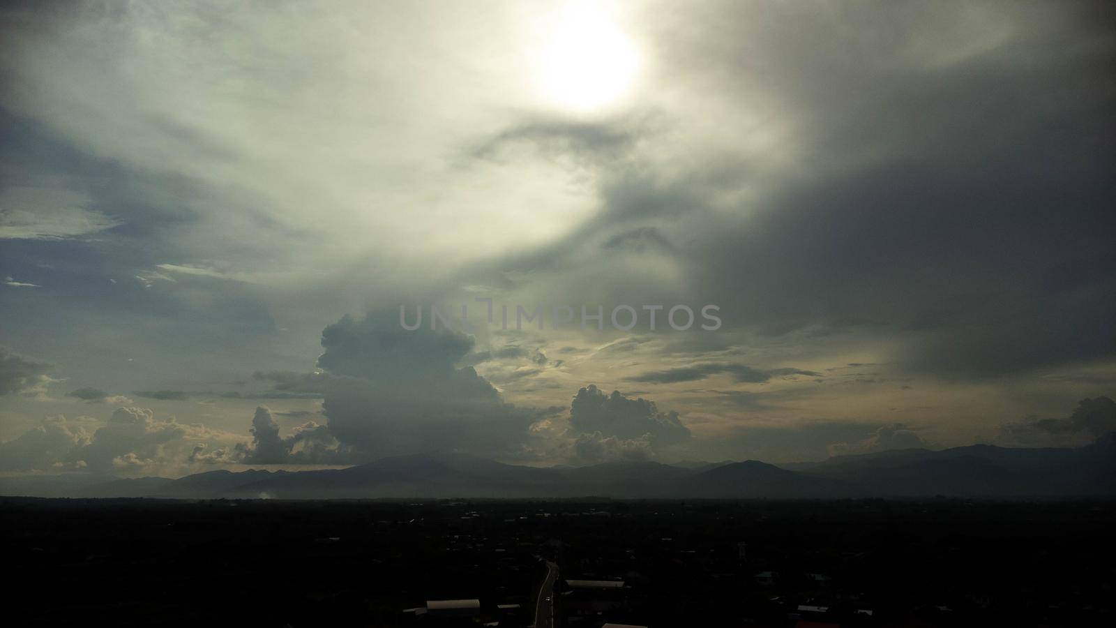 Aerial view of beautiful sky with clouds and sun in the morning. Time lapse of clouds above the blue sky with the sun shining. Sky nature background. by TEERASAK