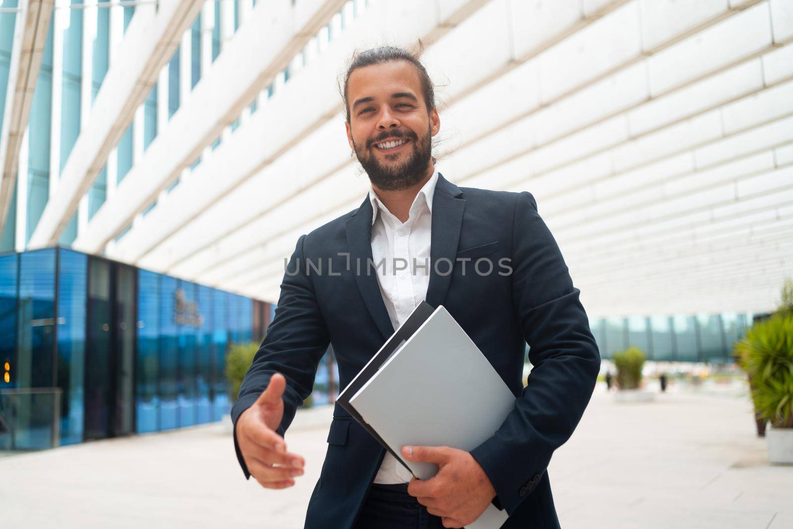 Business. Businessman Giving Hand For Handshake Welcome Gesture Adult Hispanic Male Business Person Holding Document Paper Give Hand Ready Handshake Office Building Background