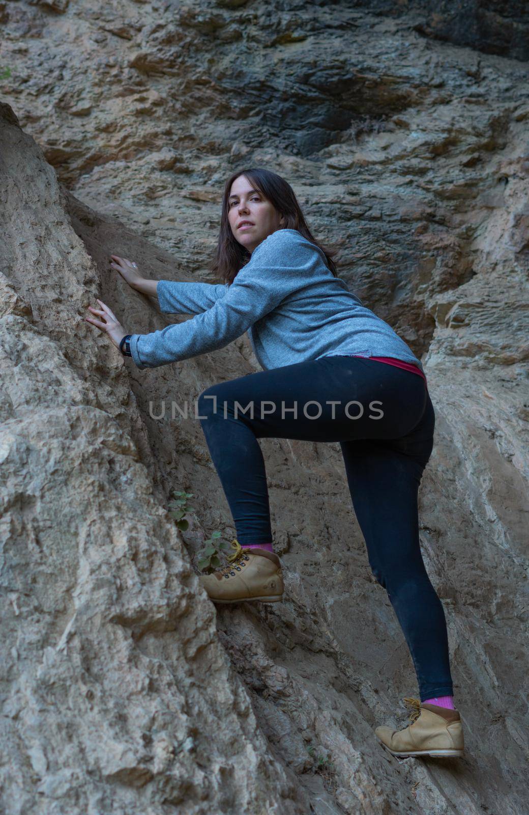 young woman rock climbing by joseantona