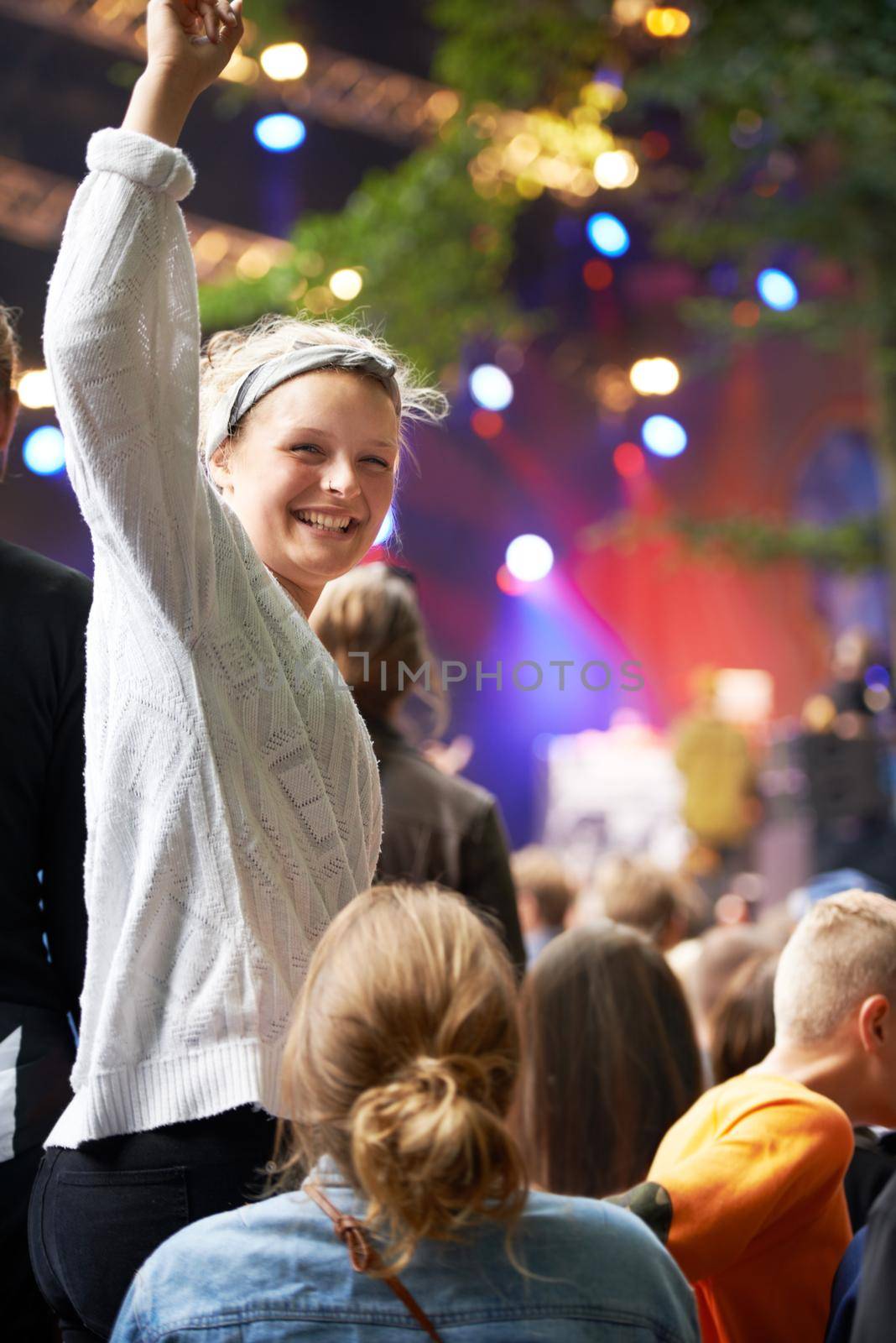Excitement at the show. young people enjoying an outdoor music festival. by YuriArcurs
