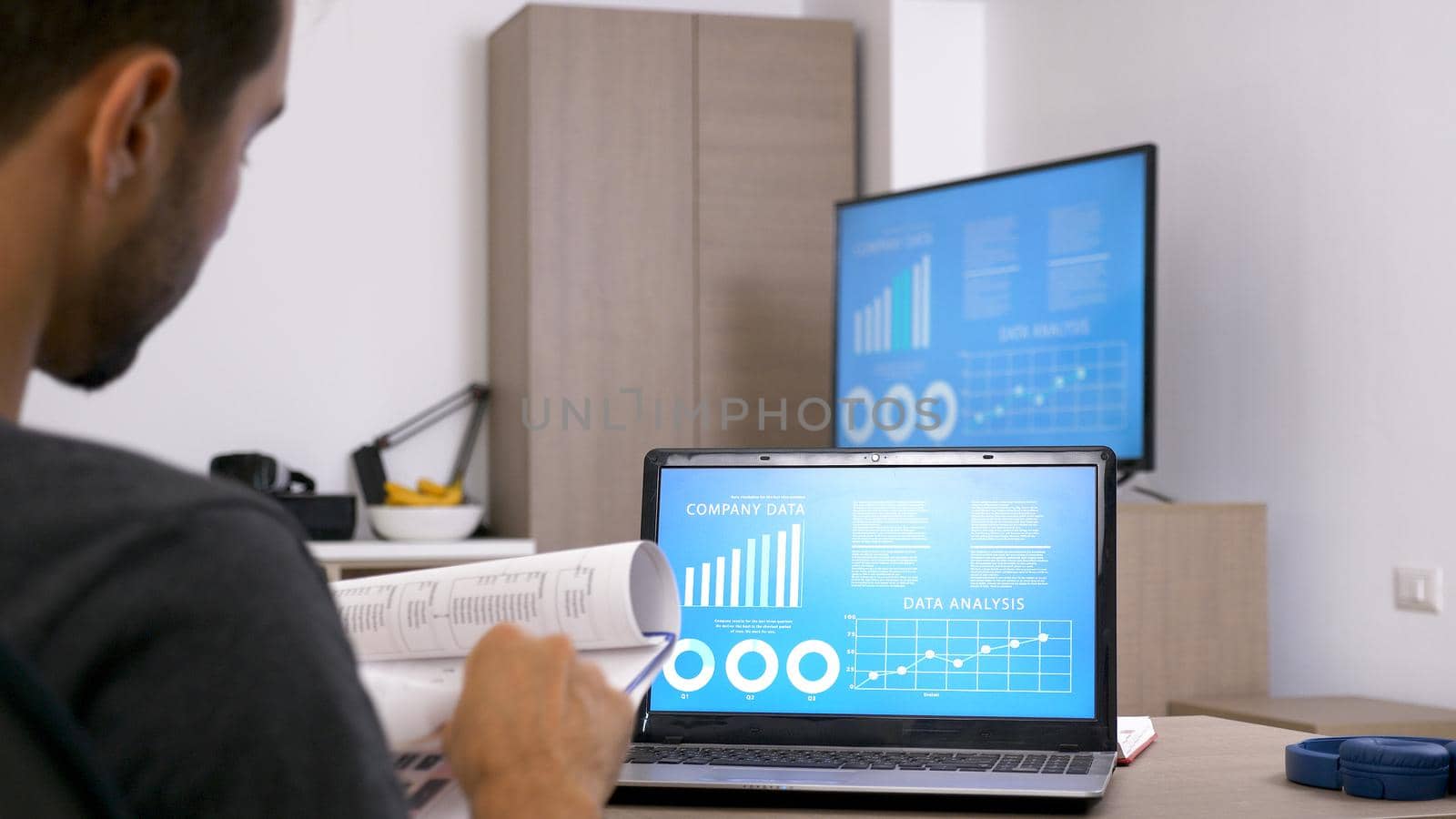 Business man with beard working hard at his desk in the office. Motivated man