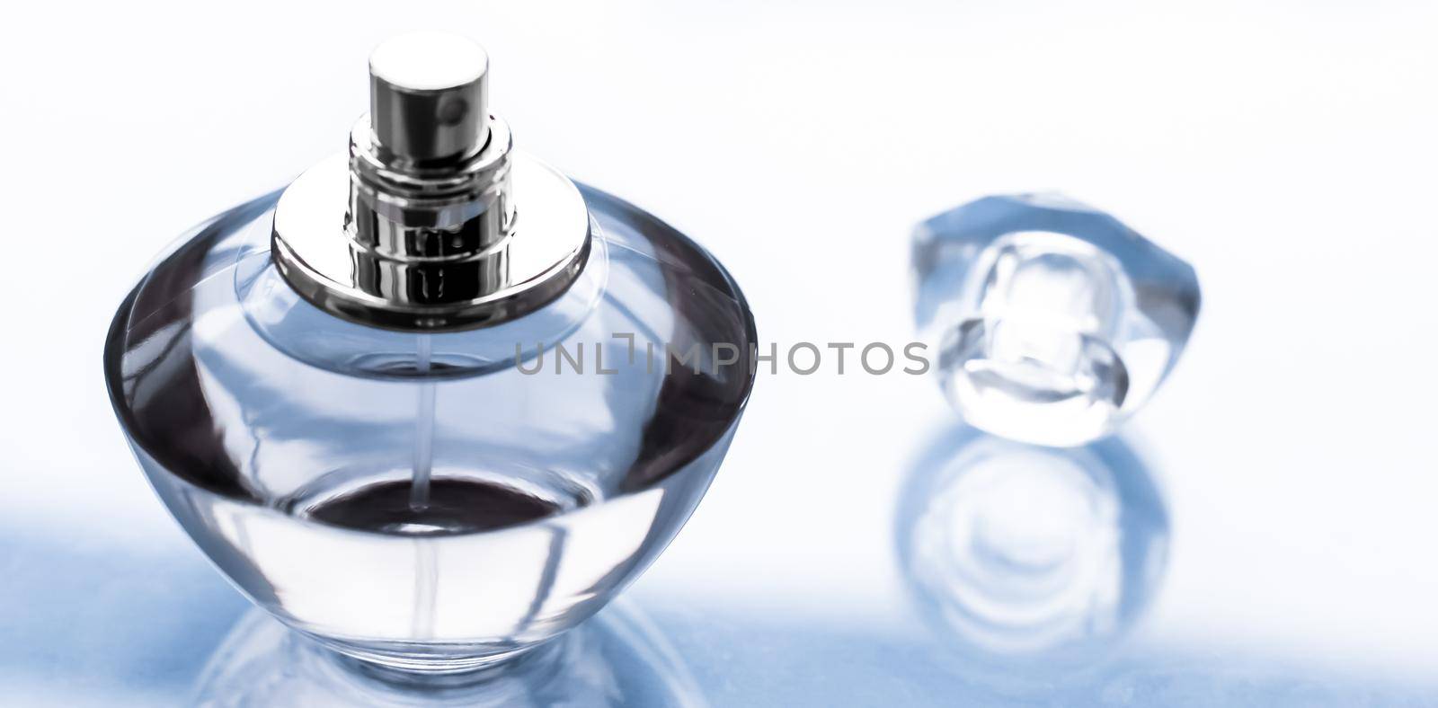 Perfumery, spa and branding concept - Blue perfume bottle on glossy background, sweet floral scent, glamour fragrance and eau de parfum as holiday gift and luxury beauty cosmetics brand design