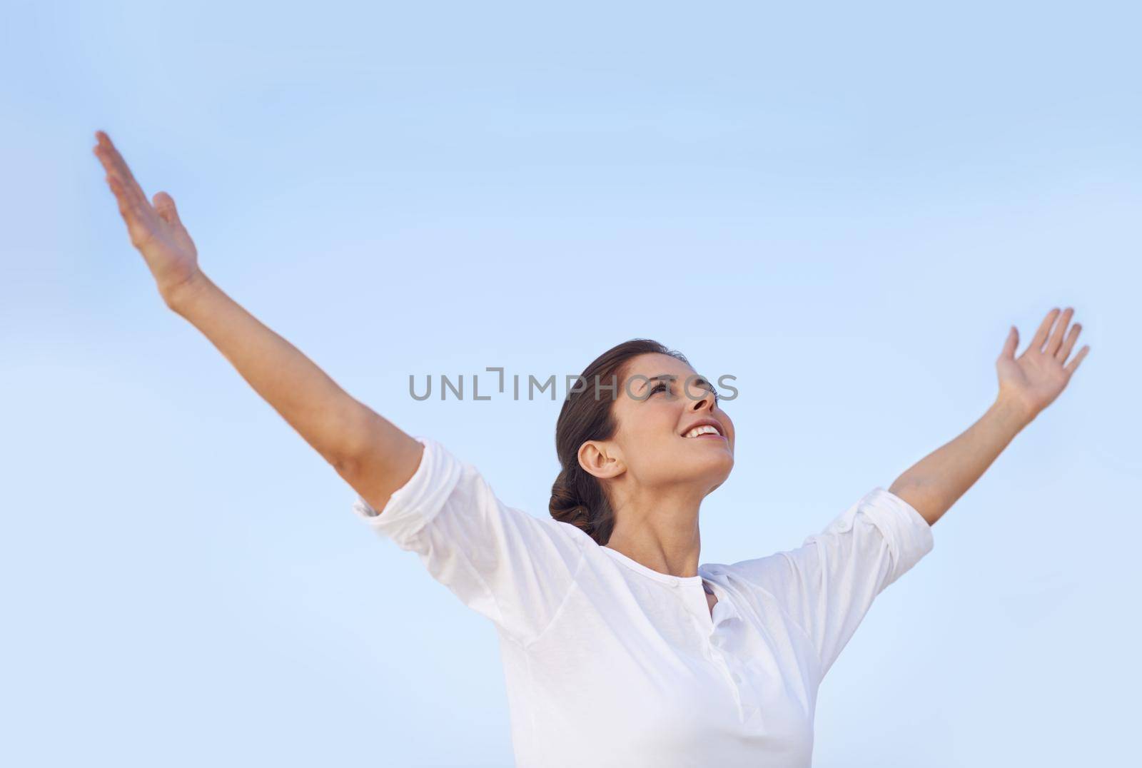 Feel the freedom. A young woman standing with her arms outstretched