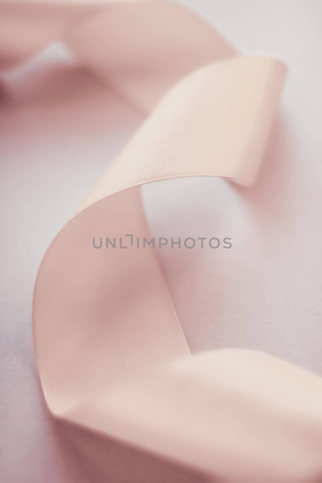 Branding, holidays and luxe brands concept - Abstract curly silk ribbon on pastel background, exclusive luxury brand design for holiday sale product promotion and glamour art invitation card backdrop