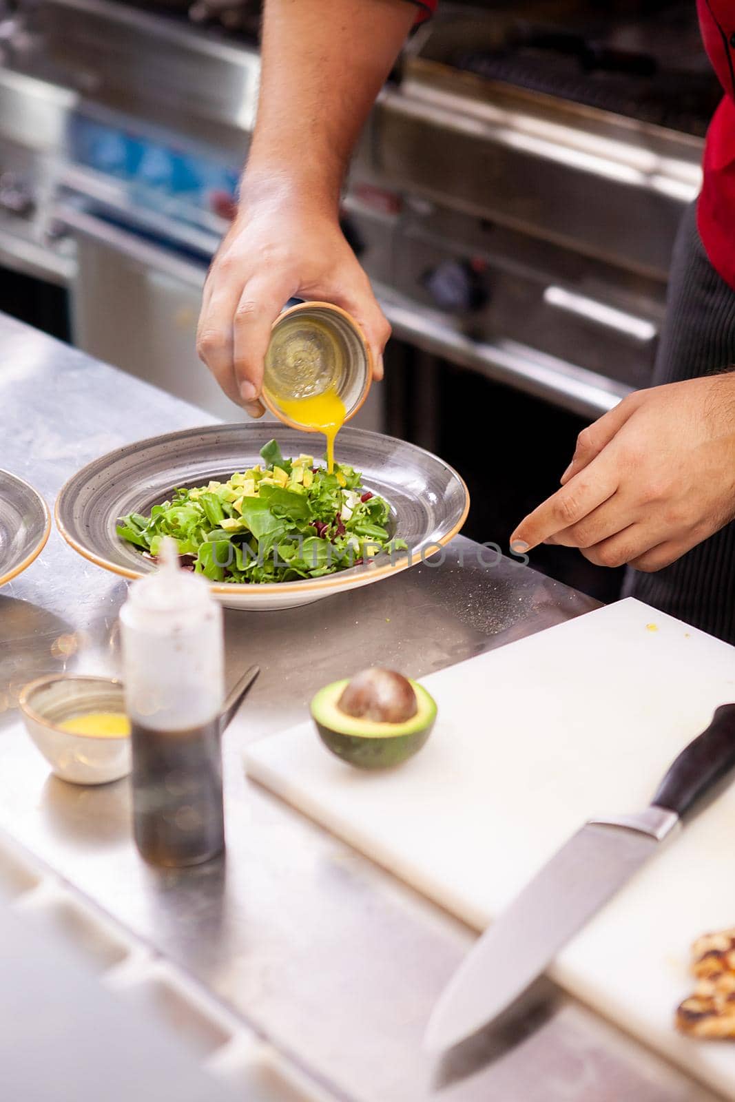 Chef seasoning salade with lemon juice ,Delicious fresh food