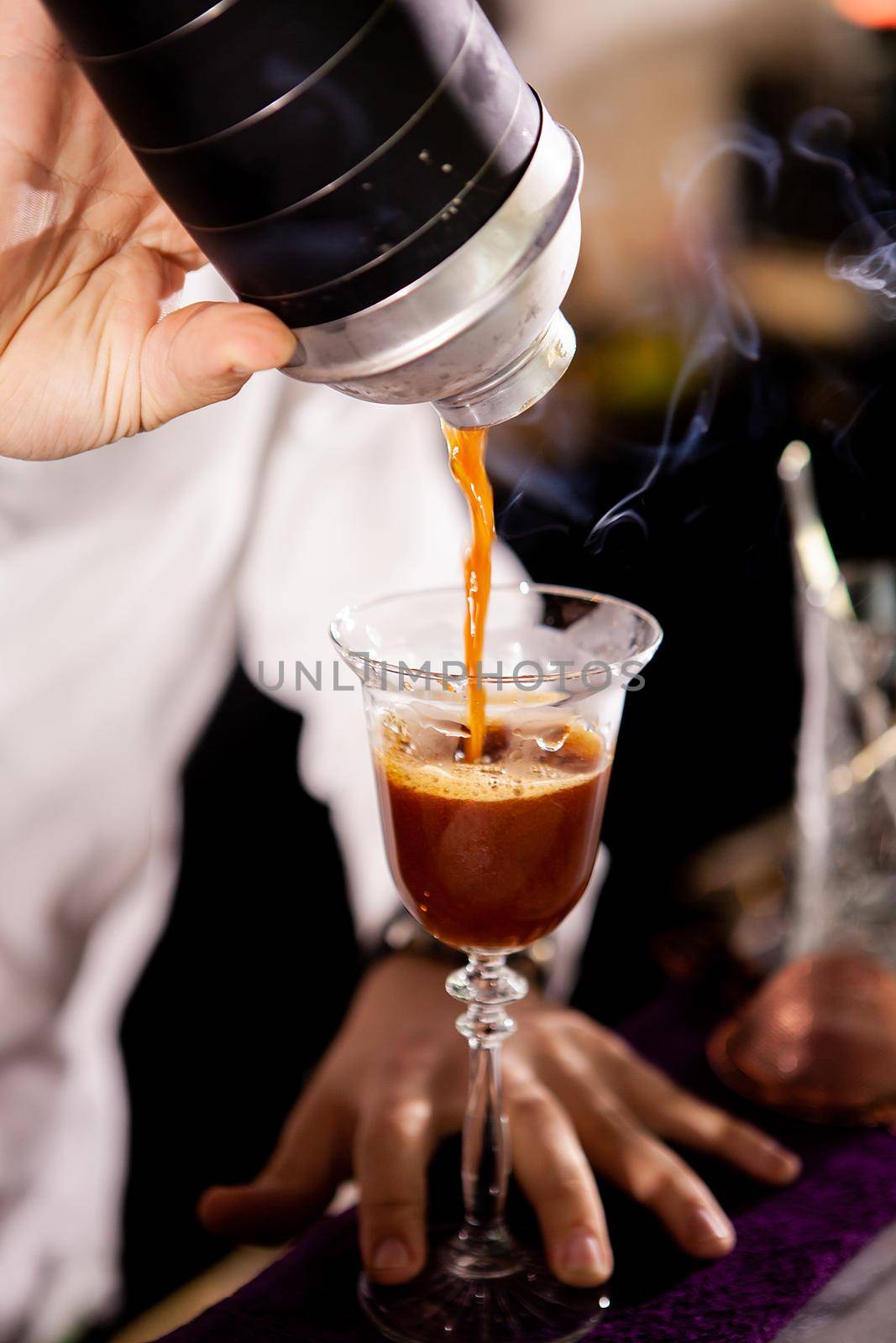 Barman making alcohol coffe drink.Pouring drink