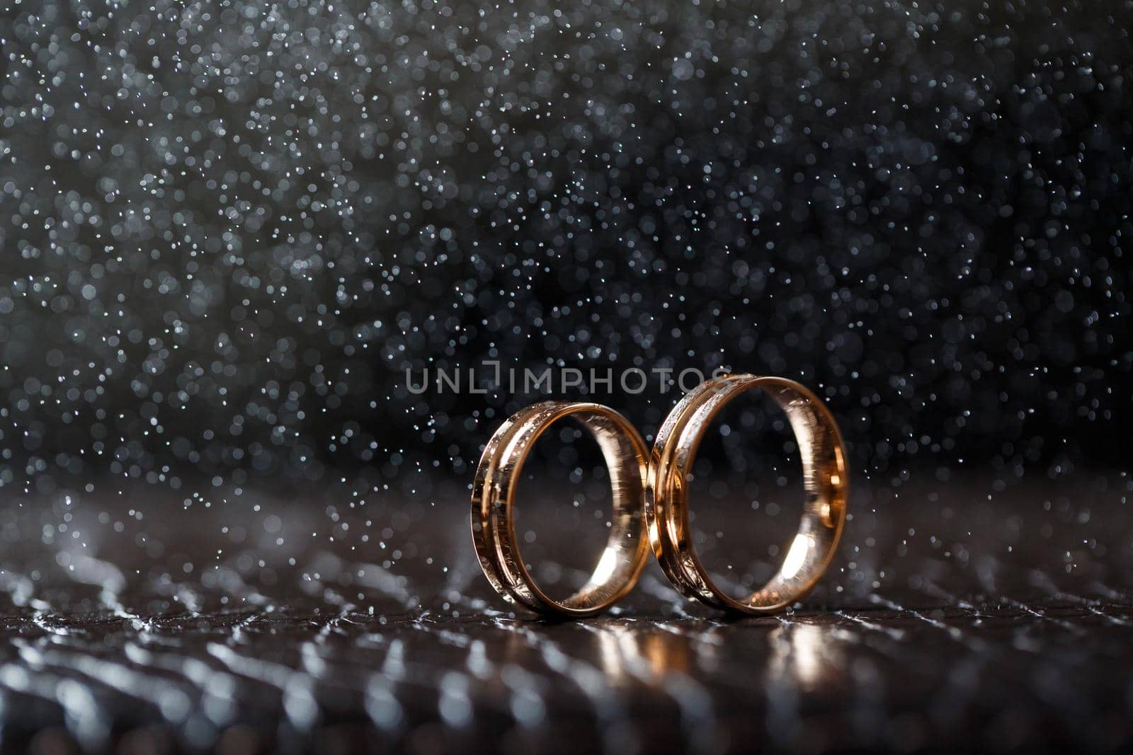 Wedding rings with water droplets,The engagement ring set.,Beautiful silver background with wedding rings and stars by Dmitrytph