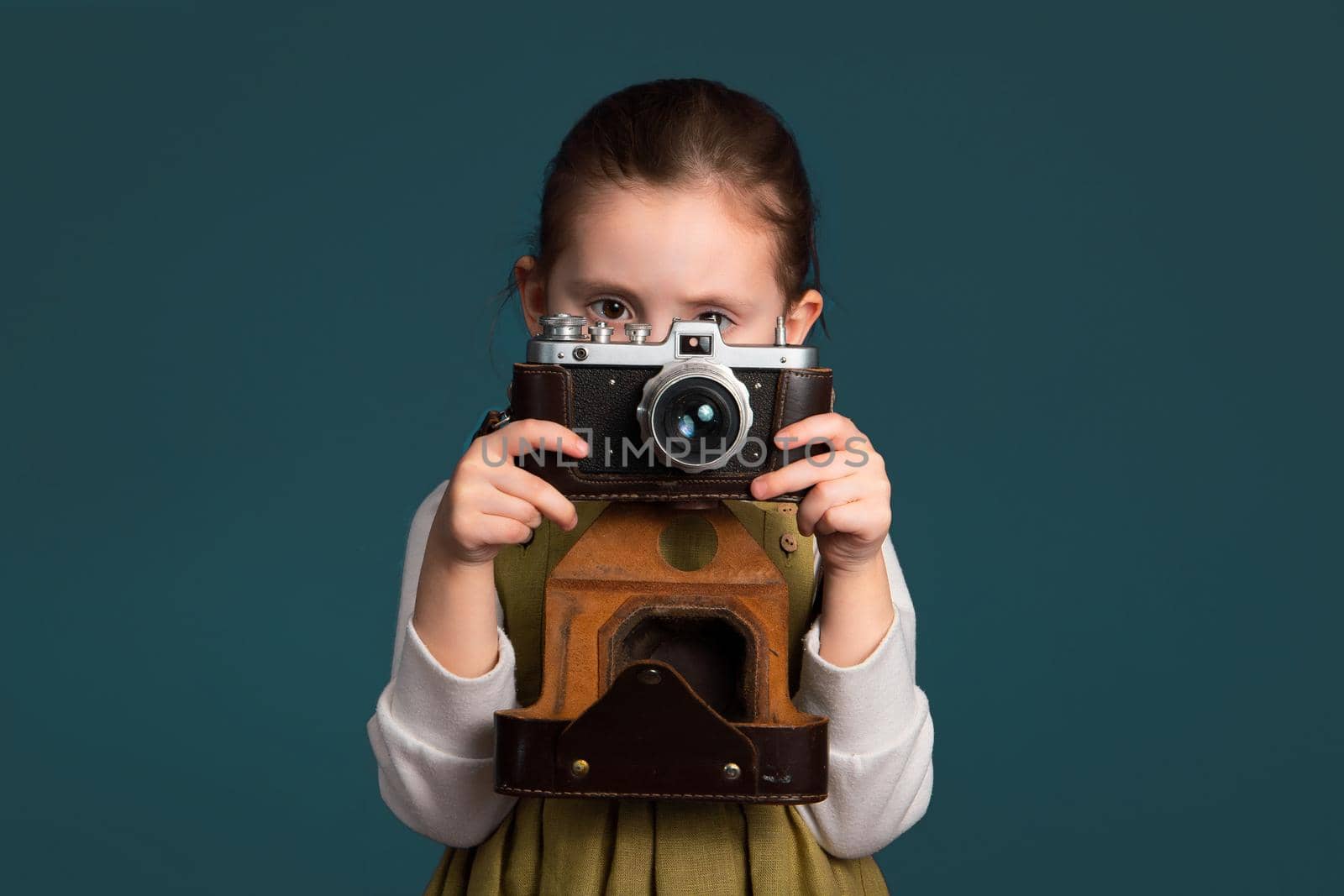 Cute little girl is serious about the art of photography.