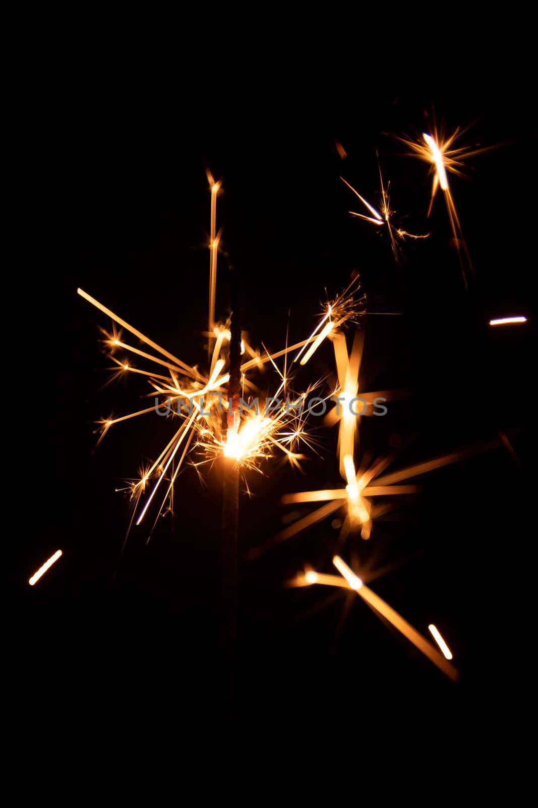 Real sparkler with sparks on black background for overlay blending mode.