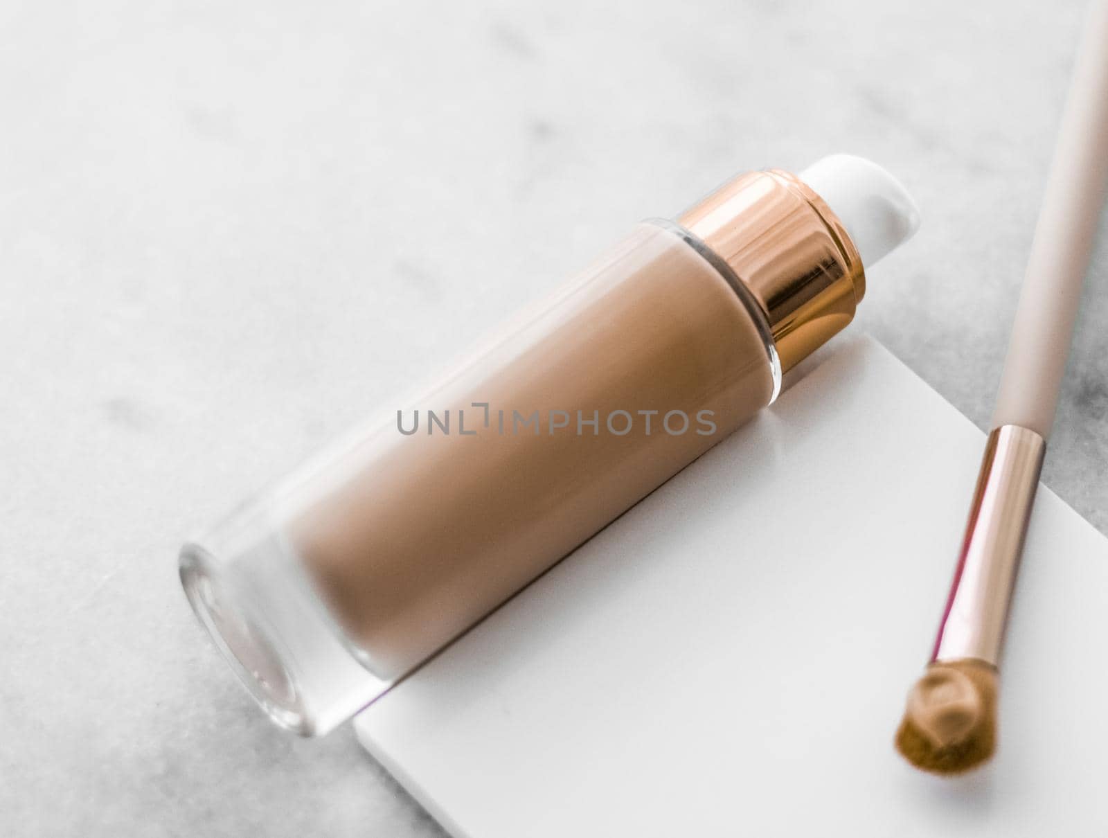 Cosmetic branding, glamour and skincare concept - Makeup foundation bottle and contouring brush on marble, make-up concealer bb cream as cosmetics product for luxury beauty brand holiday design