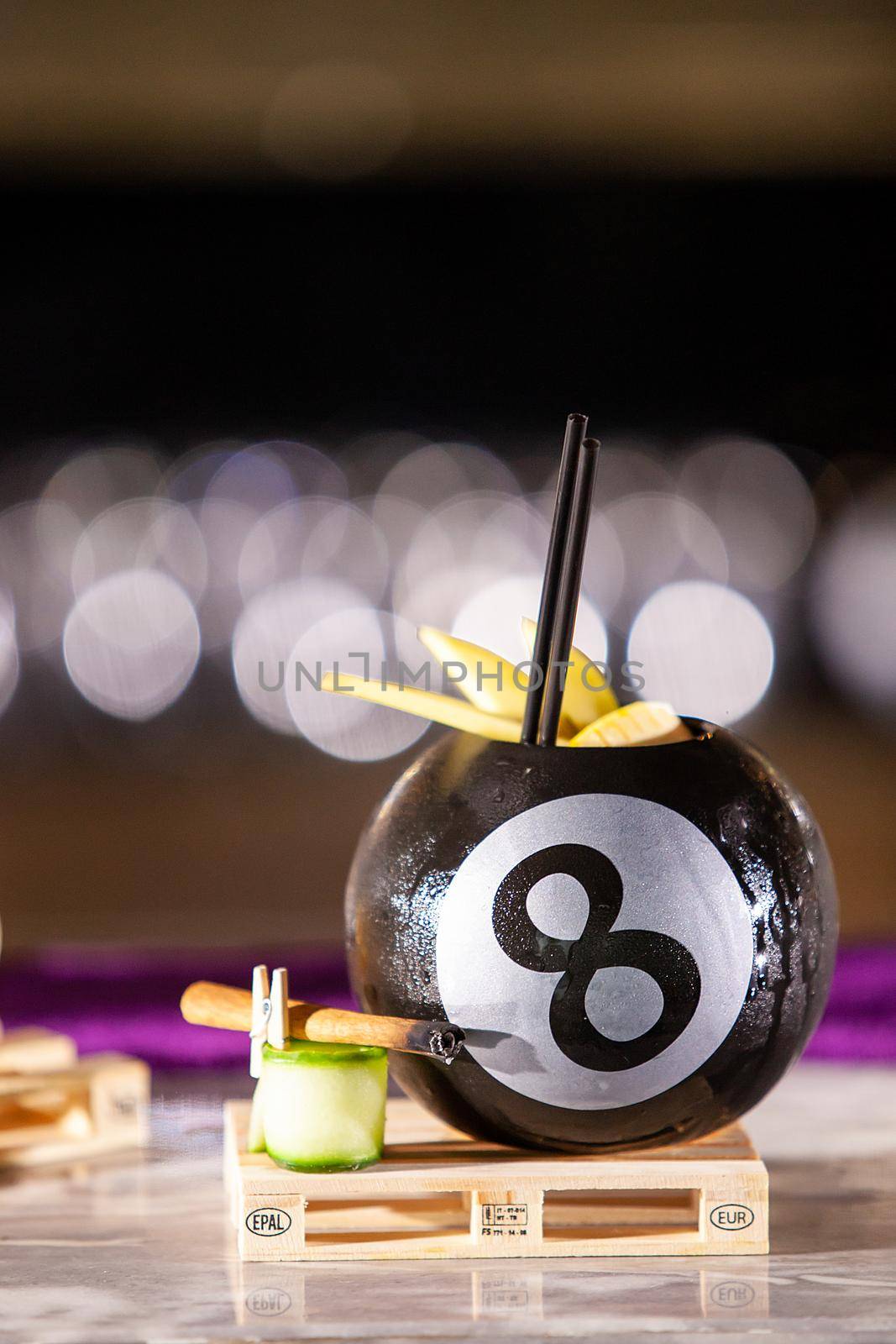 Cocktail in a pool bal on a bar counter by DCStudio