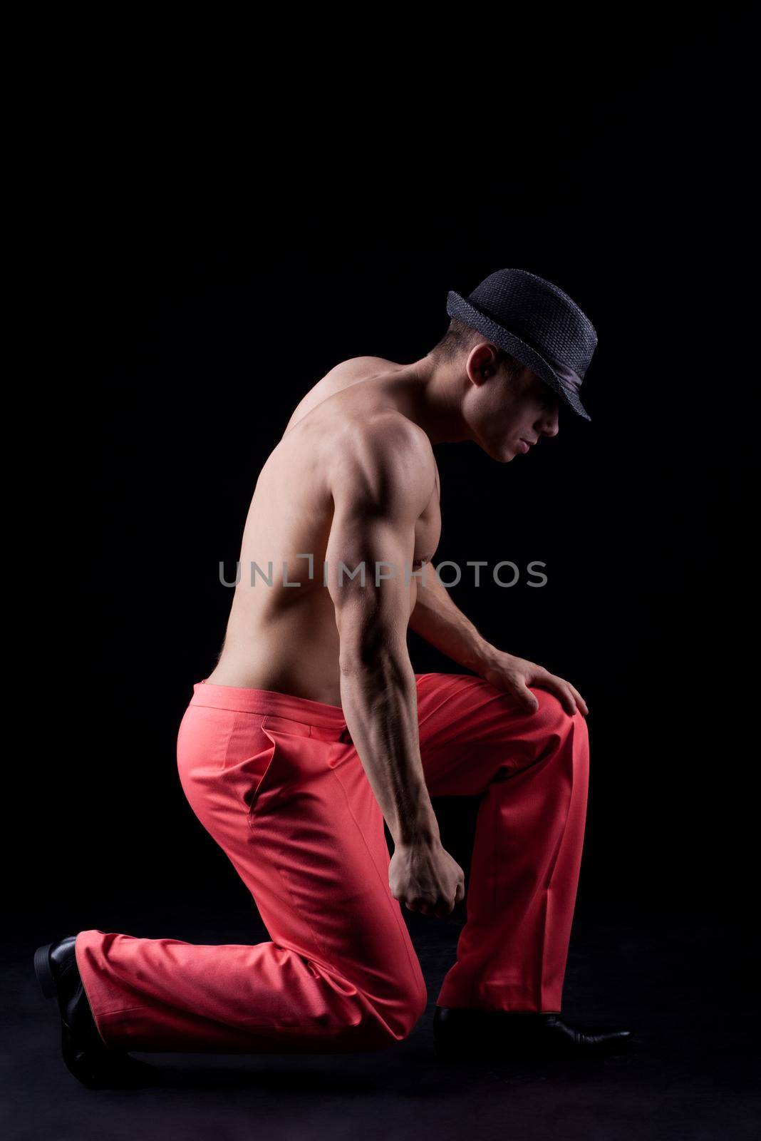 Sexy young man Dancer on black background