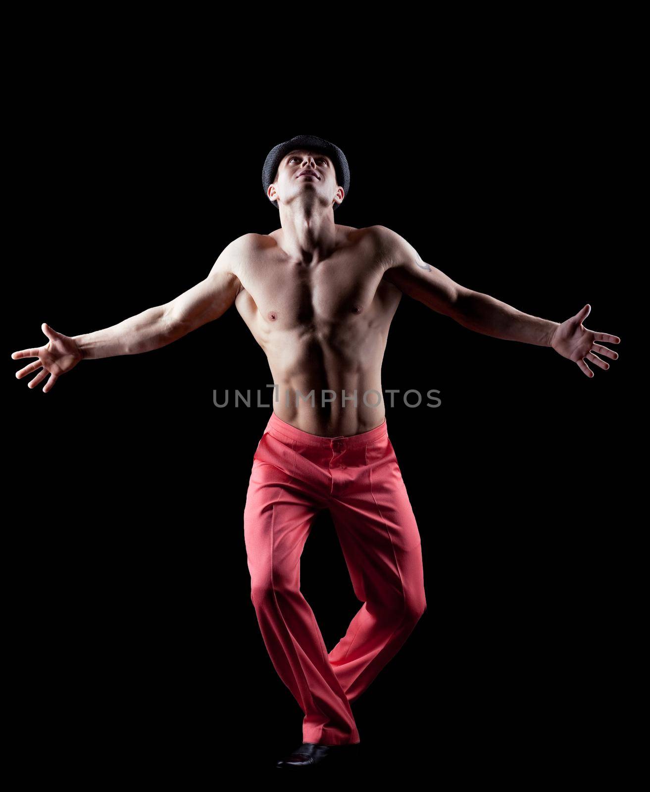 young athletic naked man dance striptease in red costume