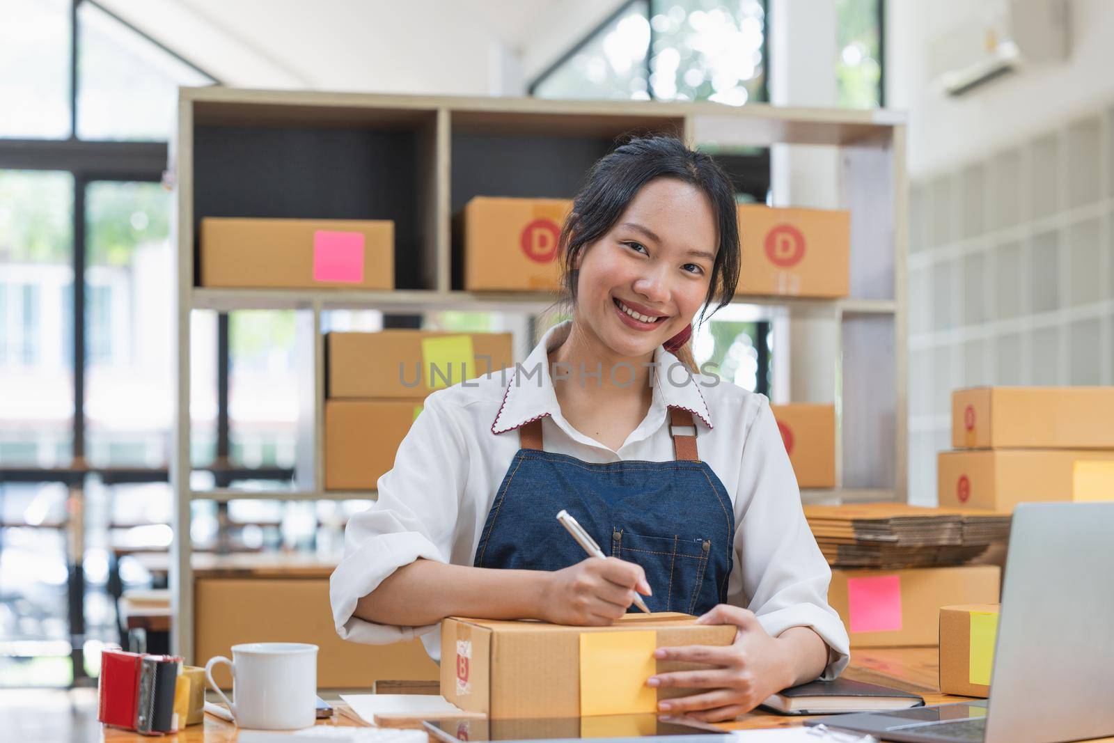Startup small business entrepreneur SME freelance woman working with box, Young asian online market packing box delivery, SME delivery e-commerce telemarketing seller concept