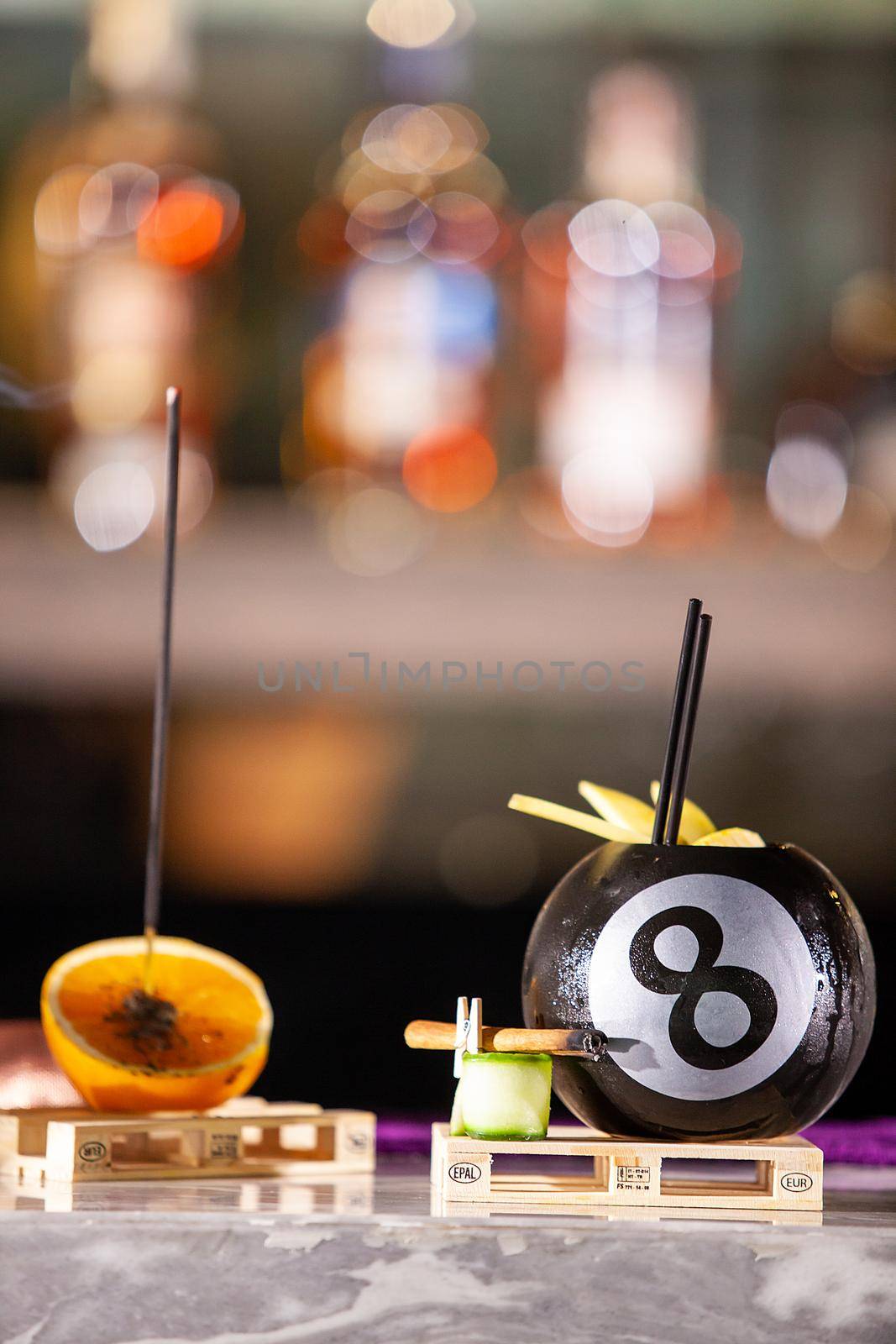 Cocktail in a pool bal on a bar counter by DCStudio