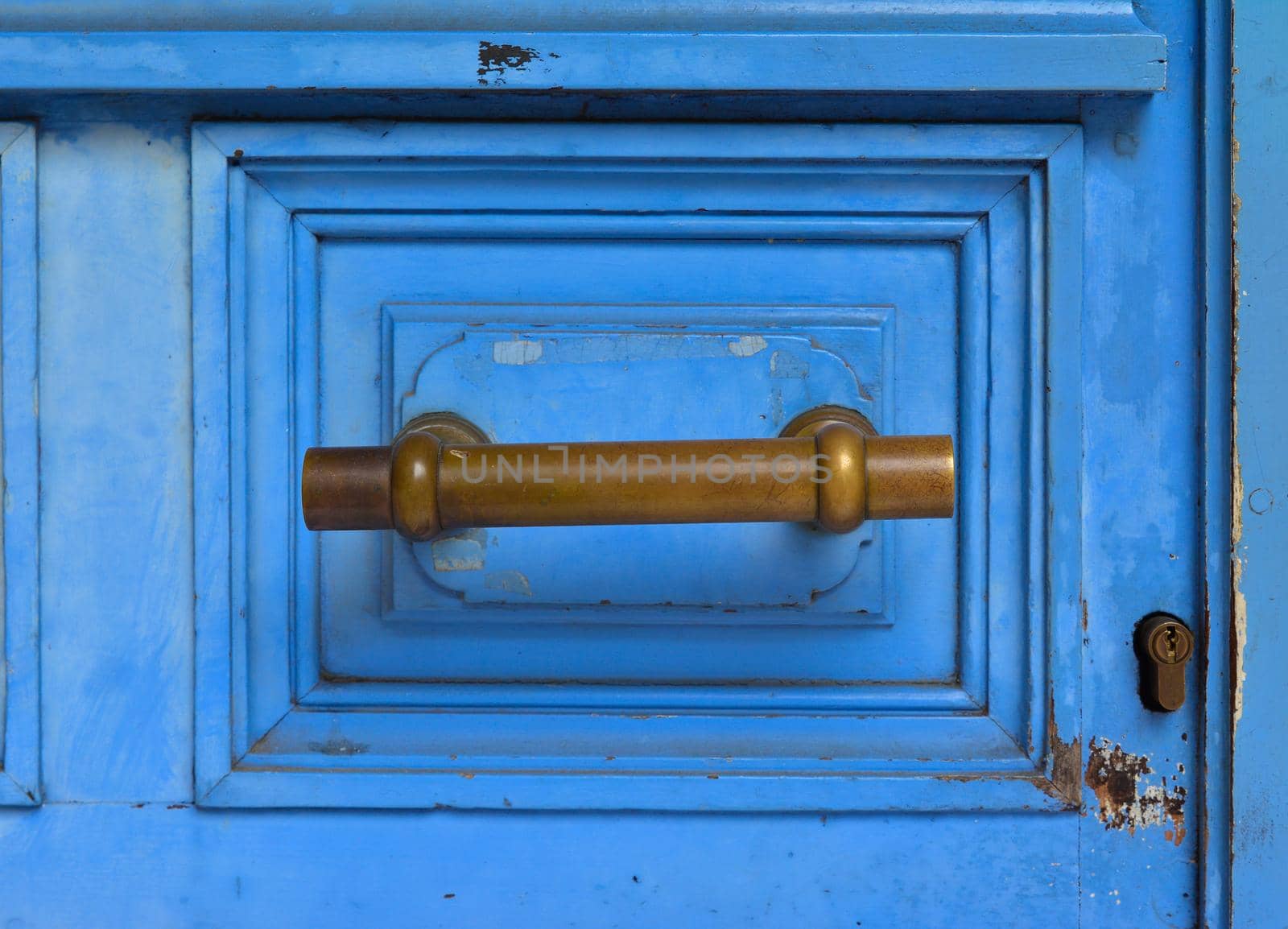 Blue handle door rusty iron handle in wood doorway
